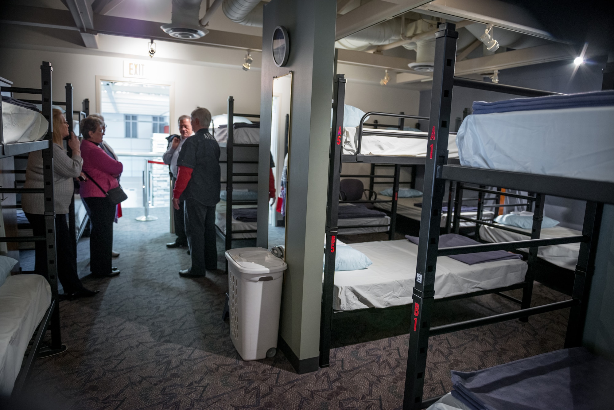 Volunteers show guests one of the available bunkrooms at the Armed Forces Service Center at the Minneapolis-St. Paul International Airport during an open house and dedication ceremony for a new Veterans Wall sponsored by the MAC.  The AFSC is a 24/7 non-profit facility that has served military members and their families at the MSP airport since 1970.  (U.S. Air Force photo by Shannon McKay/Released)