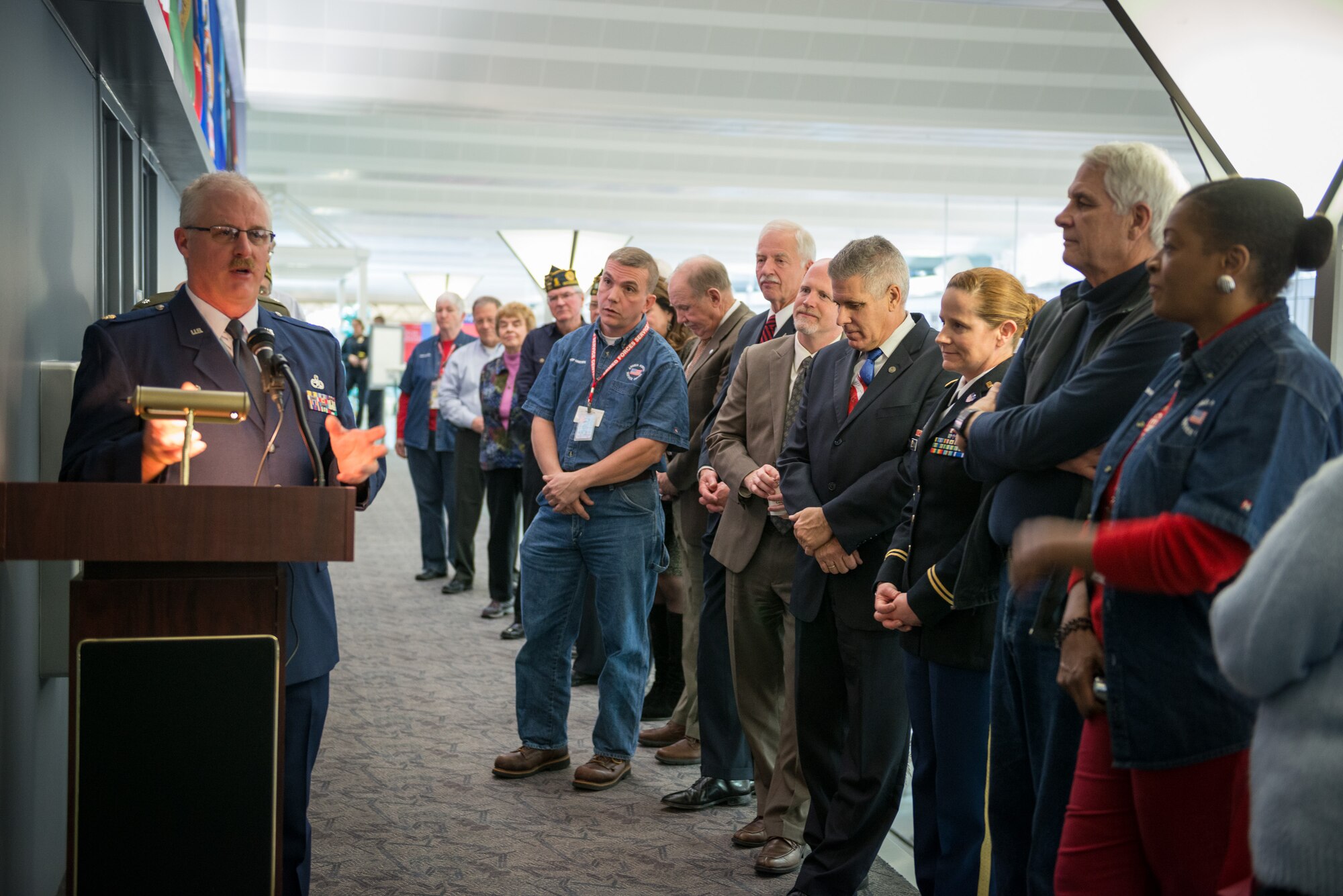 Maj. J. Arnold Clamon, 934th Aircraft Maintenance Squadron commander, speaks to the crowd at the Armed Forces Service Center open house at the Minneapolis-St. Paul International Airport during a  dedication ceremony for a new Veterans Wall sponsored by the Metropolitan Airports Commission.  The AFSC is a 24/7 non-profit facility that has served military members and their families at the MSP airport since 1970.  (U.S. Air Force photo by Shannon McKay/Released)