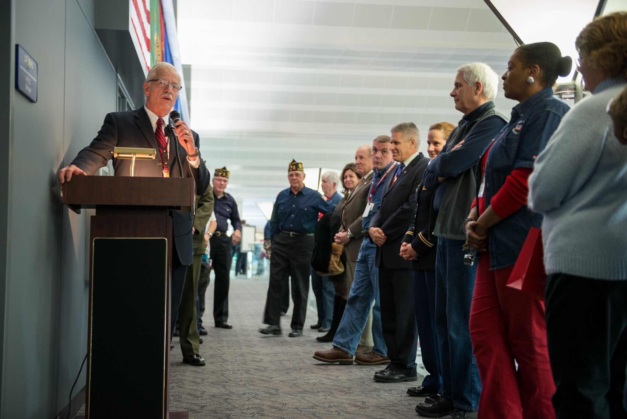 Lt. Col. (Ret.) Jeff Hamiel, Metropolitan Airports Commission (MAC) executive director, speaks to the crowd at the Armed Forces Service Center open house at the Minneapolis-St. Paul International Airport during a  dedication ceremony for a new Veterans Wall sponsored by the MAC.  The AFSC is a 24/7 non-profit facility that has served military members and their families at the MSP airport since 1970.  (U.S. Air Force photo by Shannon McKay/Released)