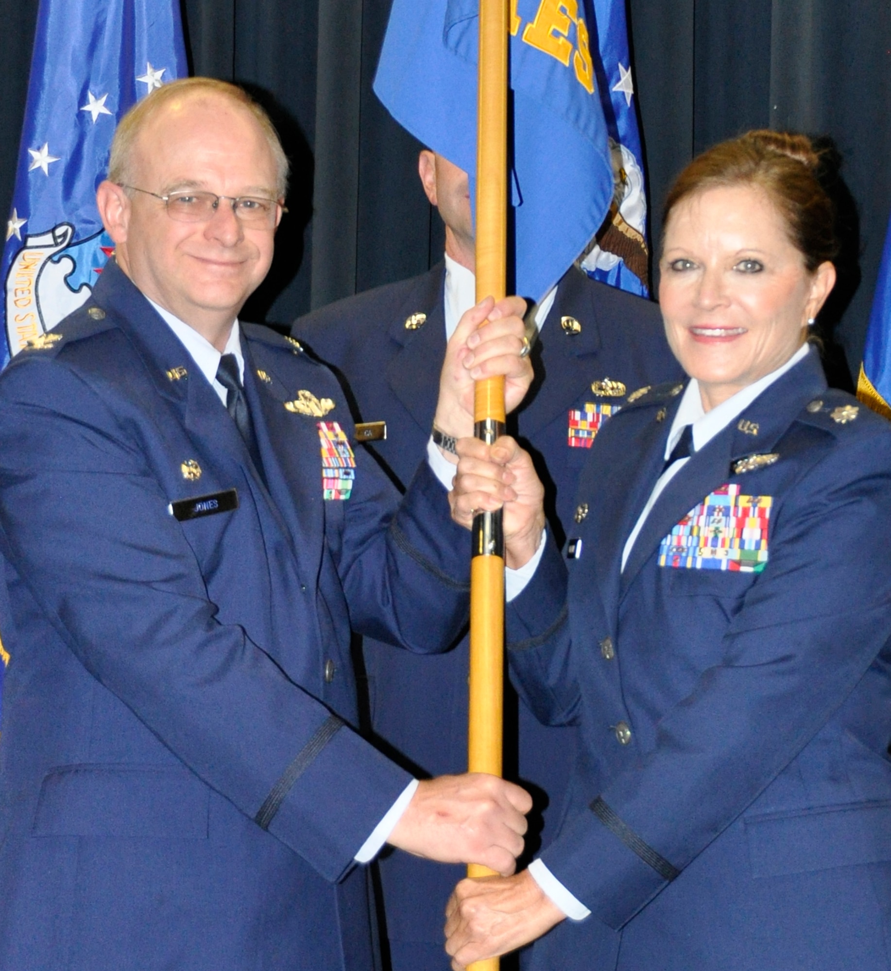 PETERSON AIR FORCE BASE, Colo. Lt. Col. Laurel McDaniel accepts the 34th Aeromedical Evacuation Squadron guideon from Col. Kurt Jones during a change of command ceremony Nov. 2, 2014 here. As the commander, McDaniel will be responsible for the leadership and management of approximately 75 assigned officers and enlisted members who provide global aeromedical evacuations well as medical care and coordination of aeromedical evacuation missions. McDaniel took command from Lt. Col. Monsita Faley, who will take command of the 452nd Aeromedical Evacuation Squadron, March AFB, Calif. (U.S. Air Force photo/Maj. Corinna Moylan) 