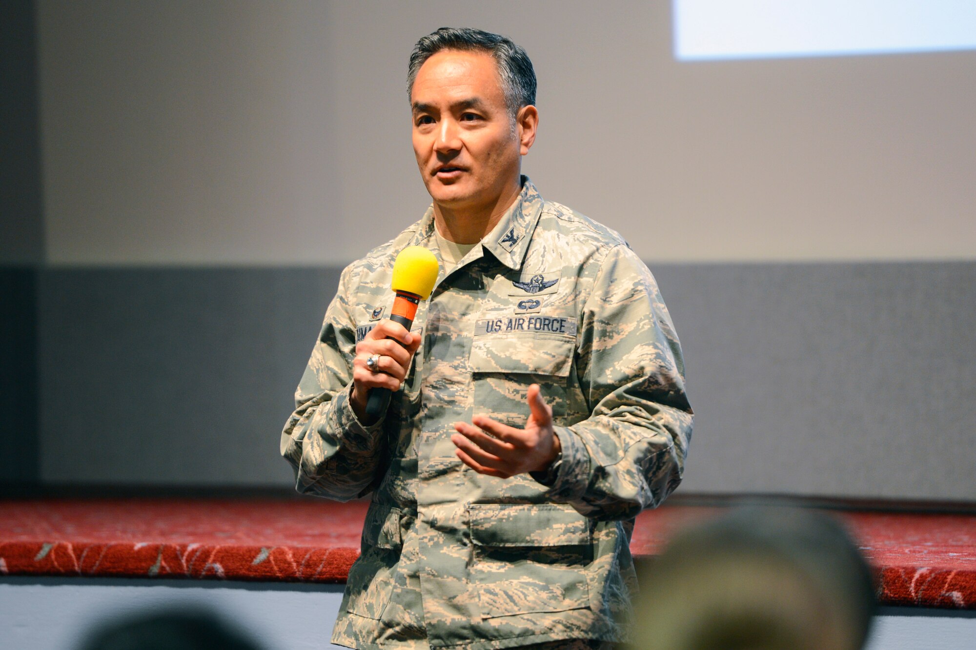 Col. David Kumashiro, 62nd Airlift Wing commander, answers questions from audience members at the McChord Field Theater, Joint Base Lewis-McChord, Wash., Nov. 13, 2014, during the JBLM Town Hall Ebola update. After Marcum’s briefing, JBLM leaders took questions from audience members hoping to answer all of their questions and putting to ease any remaining concerns. (U.S. Air Force photo/Staff Sgt. Russ Jackson)