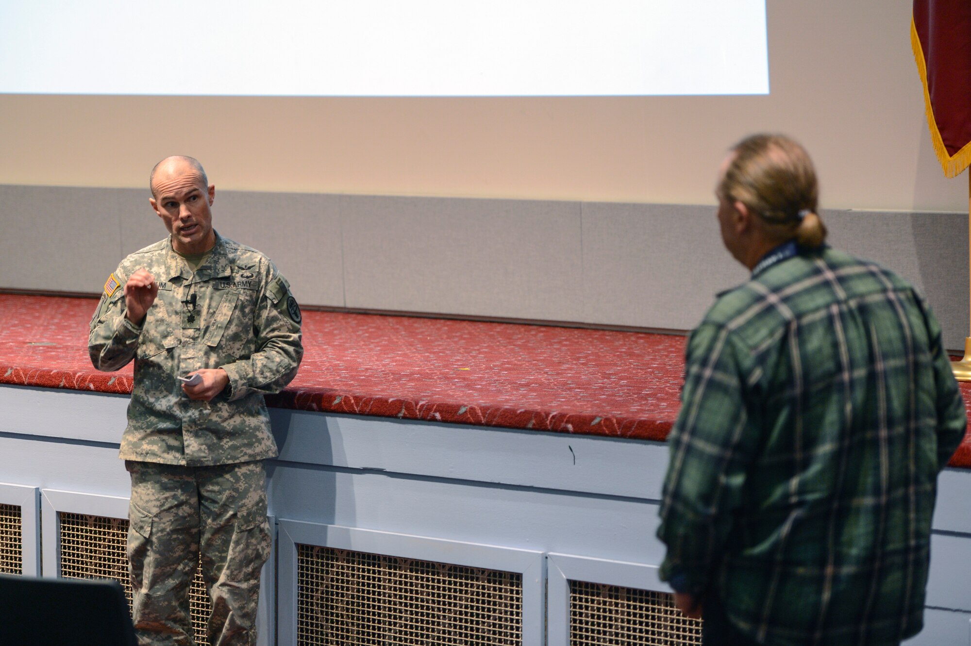 Lt. Col. Rodd Marcum, Madigan Preventative Medicine physician, answers a question from a civilian at the McChord Field Theater, Joint Base Lewis-McChord, Wash., Nov. 13, 2014, during the JBLM Town Hall Ebola update. Marcum tried to set fears of developing the virus at ease by explaining it cannot be contracted through the air, via an insect bite, or through consumption of food or water. (U.S. Air Force photo/Staff Sgt. Russ Jackson)