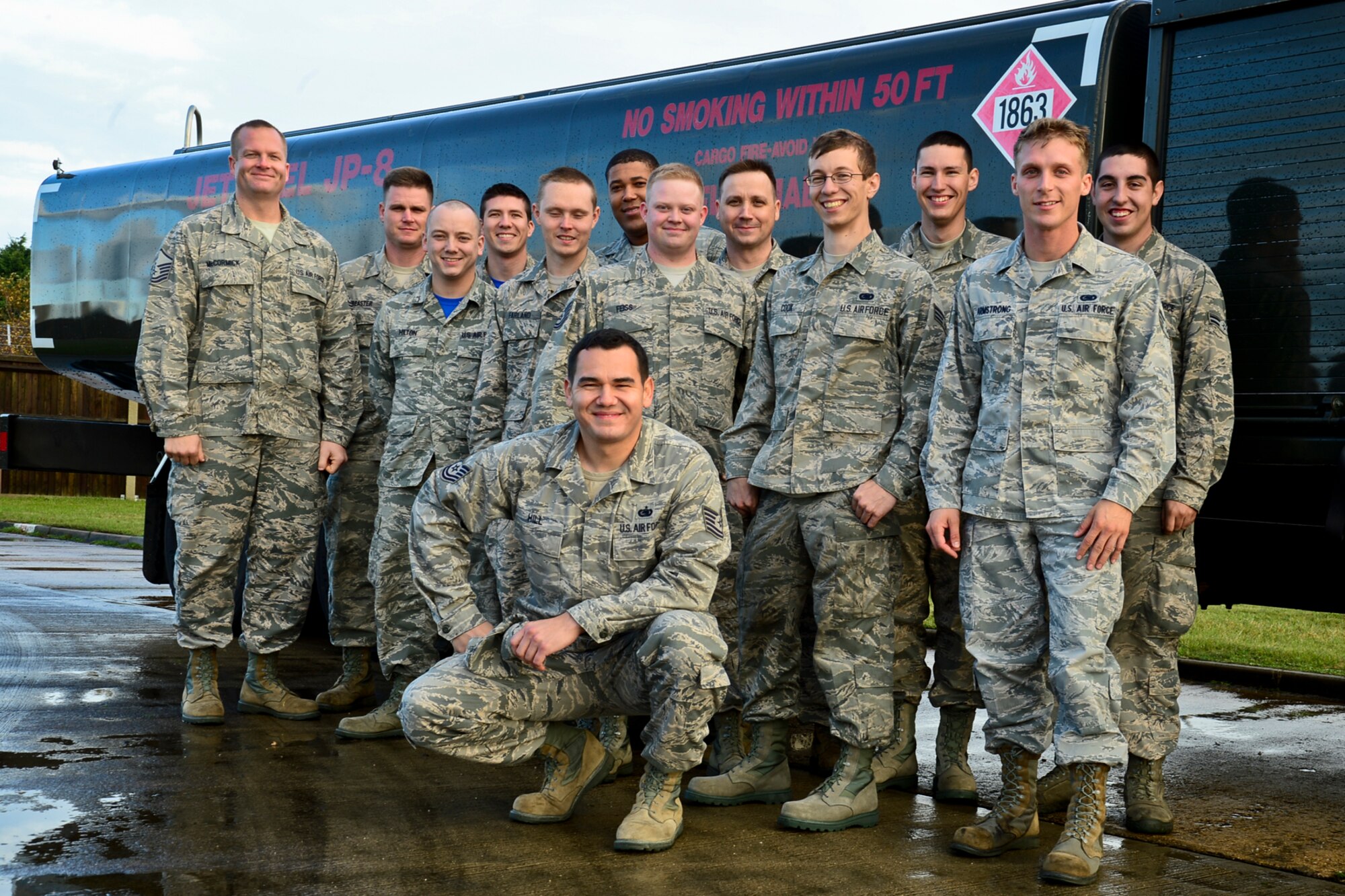 Tech. Sgt. Edward Hill, 48th Logistics Readiness Squadron fuels environmental safety office manager, poses in front of a fuel truck with 48th LRS Airmen at Royal Air Force Lakenheath, England, Nov. 7, 2014. Hill was nominated for a Liberty Spotlight because he displays the core value of Excellence in All We Do. (U.S. Air Force photo by Airman 1st Class Erin R. Babis/Released)