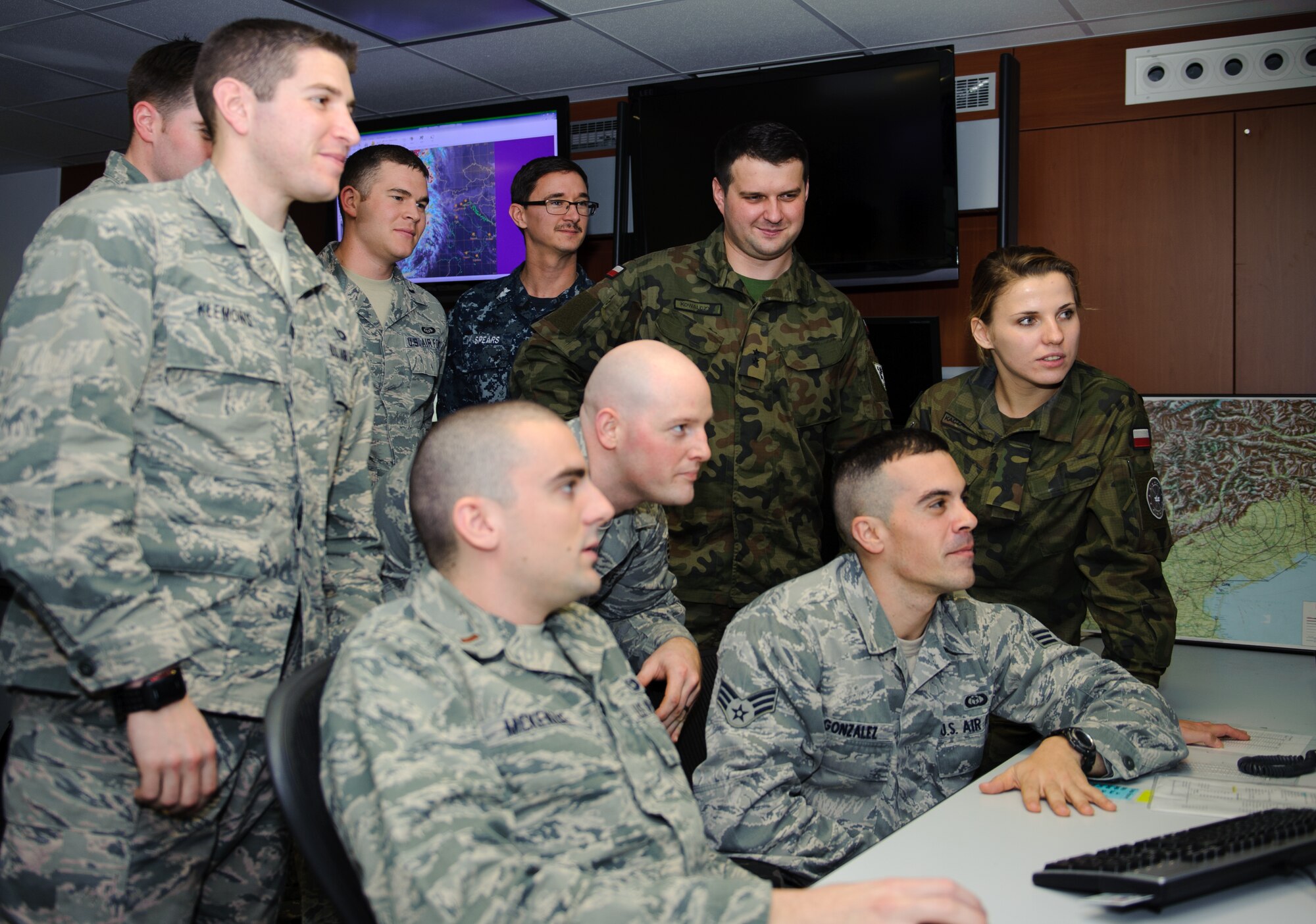 Members of the 21st Operational Weather Squadron take an opportunity to learn more about local weather patterns with 2nd Lts. Monika Kaczanowska and Daniel Kowalczyk, Polish Armed Forces meteorological and oceanographic officers, Nov. 14, 2014, at Kapaun Air Station, Germany. The 21st OWS showed the two Polish Armed Forces members around the United States European Command and United States Africa Command weather systems and operations. (U.S. Air Forces photo/ Senior Airman Armando A. Schwier-Morales)