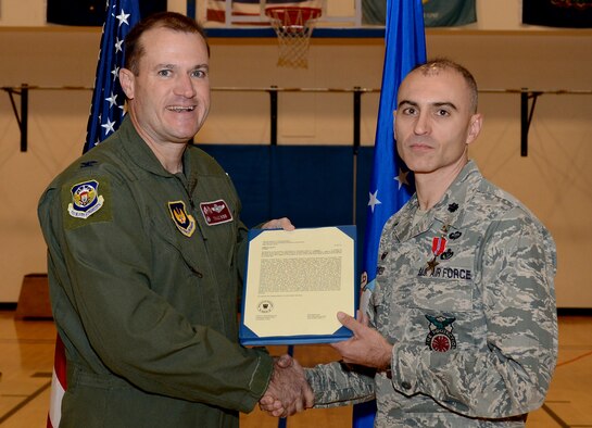 U.S. Air Force Col. Kenneth T. Bibb Jr., left, 100th Air Refueling Wing commander, presents a Bronze Star to U.S. Air Force Lt. Col. Kevin Parker, 100th Civil Engineer Squadron commander, during a commander’s call Nov. 14, 2014, on RAF Mildenhall, England. Parker received his Bronze Star for his accomplishments while in command of the 376th Expeditionary Civil Engineer Squadron June 20, 2012 to June 15, 2013, at Manas, Kyrgyz Republic. (U.S. Air Force photo by Senior Airman Kate Maurer/Released)