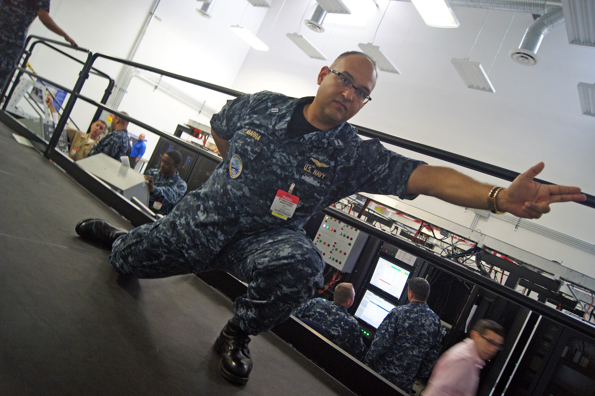 Lt. Sergio Ibarra gives the signal as fellow Sailors from the USS Gerald R. Ford’s (CVN 78) V-2 Division take part in a launch simulation at the first-of-its-kind training on the Electromagnetic Aircraft Launch System (EMALS) last month at General Atomics’ Ship Set Control Lab in San Diego, California. (Courtesy photo by General Atomics)