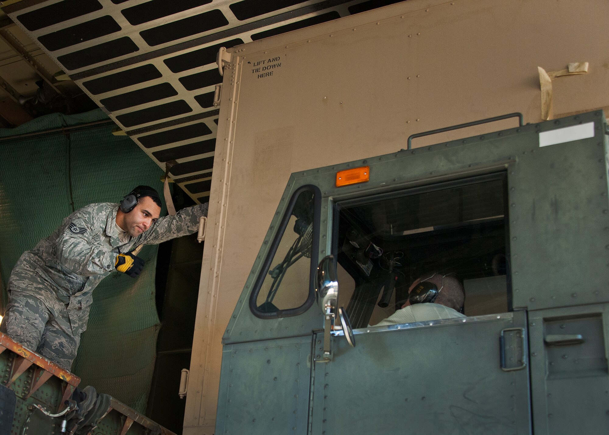 Staff Sgt.  Dominic Wimsatt , 96th Logistics Readiness Squadron’s air terminal operations, gives the thumbs up to the driver after placing a metal box onto the pallet carrier Nov. 14 at Eglin Air Force Base, Fla.  The squadron’s Port Dawgs unloaded approximately eight Army pallets from the C-5 Galaxy. The section moves an average of 160 tons of cargo and 570+ passengers per month.  (U.S. Air Force photo/Samuel King Jr.)