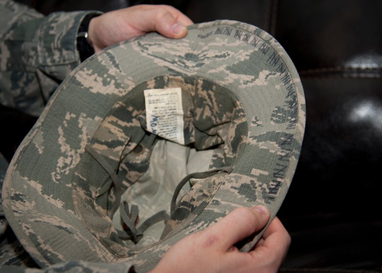 PETERSON AIRFORCE BASE, Colo. – Staff Sgt. Holden Montgomery shows the brim of the cap he used to track the number of rocket attacks he encountered during a 2010 deployment to Kandahar Air Field, Afghanistan at his home on base Nov. 14. As a result of his experiences while deployed, ‘Monty’ was diagnosed with post-traumatic stress disorder. Now receiving treatment for PTSD, Monty continues to serve his country doing the job he loves. (U.S. Air Force photo/Staff Sgt. J. Aaron Breeden)