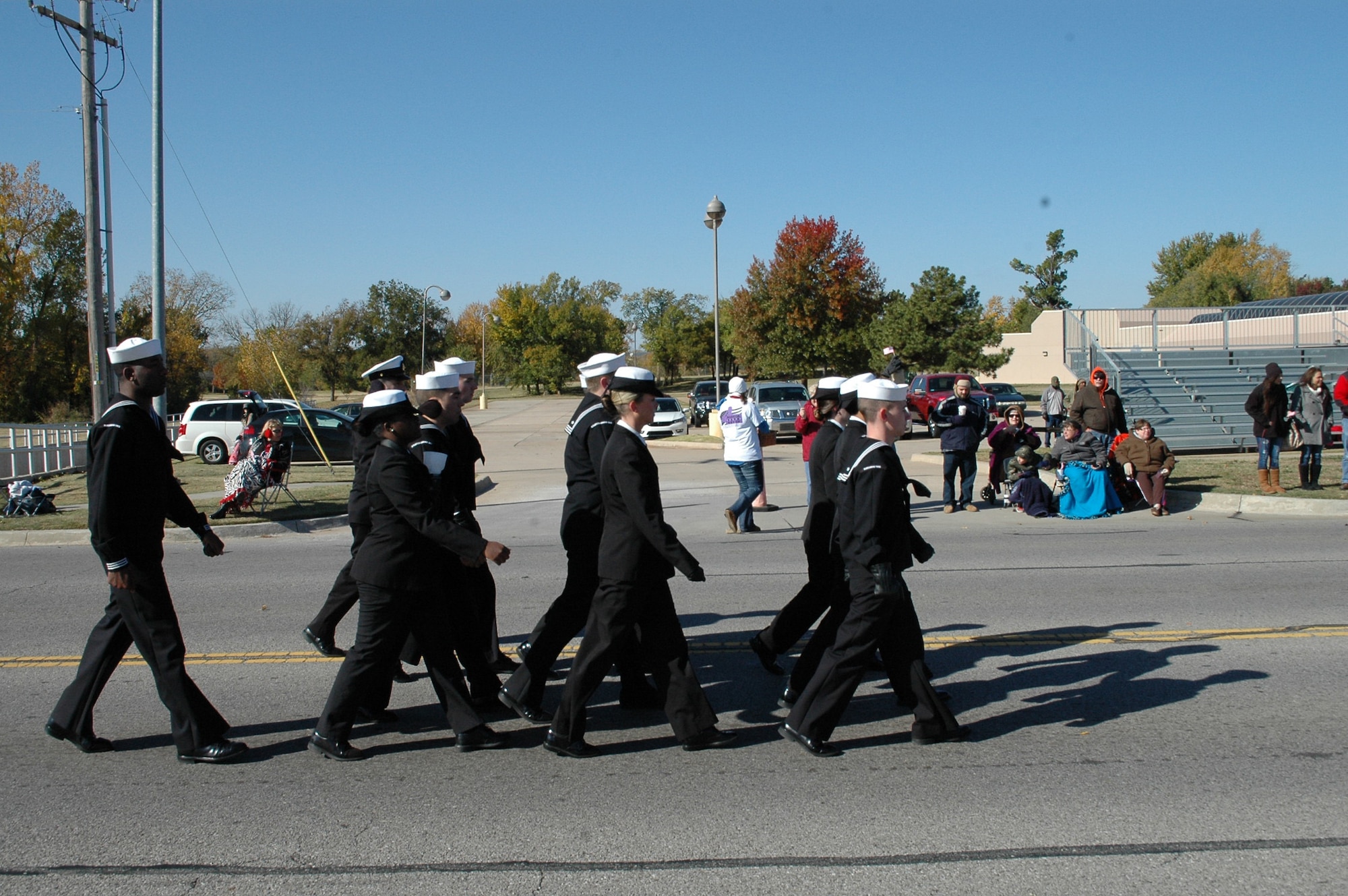 Sailors make their way down Douglas Boulevard Tuesday during the Midwest City Veterans Day parade. The parade featured more than 75 entries, including a fly-over by the Warbirds, a World War II vintage aircraft team. (Air Force photo by Ralph Monson)