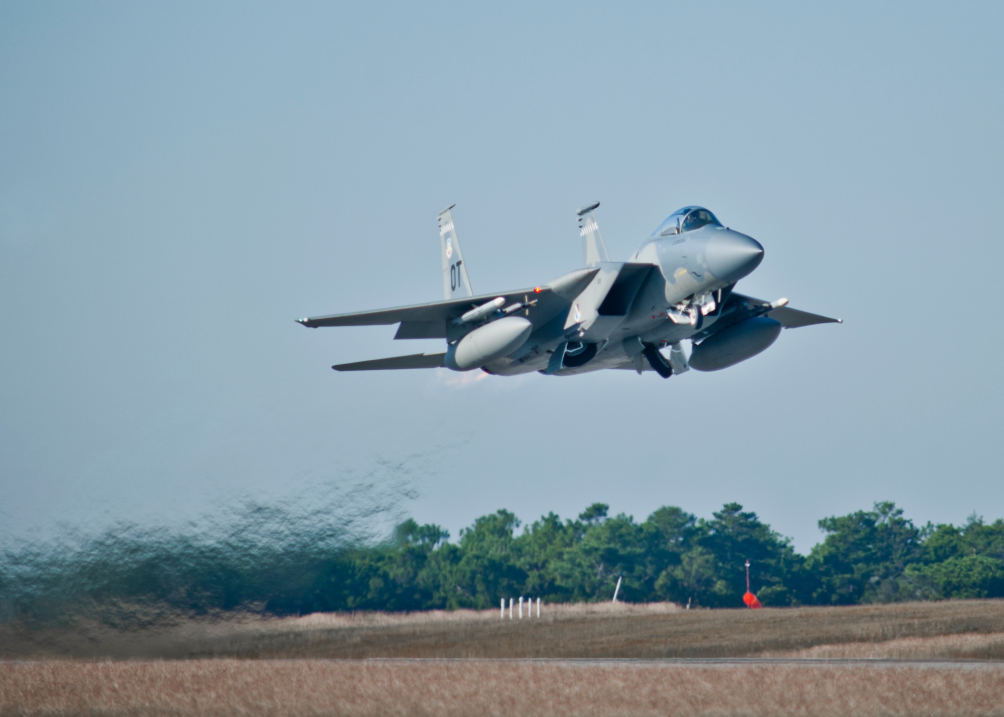 A 53rd Wing F-15 Eagle takes off from one of Eglin Air Force Base’s runways as a 33rd Fighter Wing F-35 Lightning II taxies onto another.  The F-15 is used for operational test missions while the F-35 is used to train pilots. (U.S. Air Force photo/Samuel King Jr.)