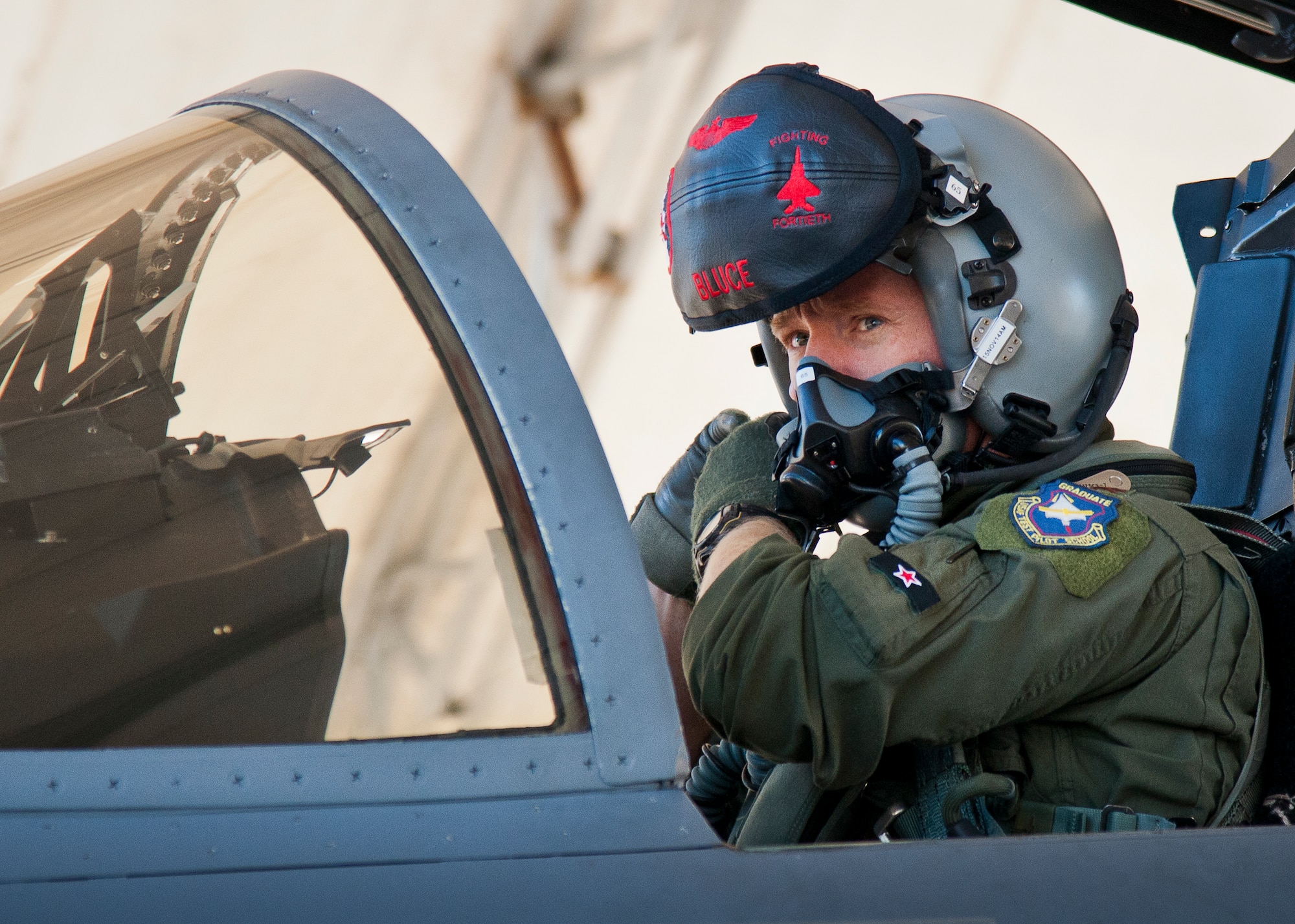 Maj. Christopher Wee, Operation Flight Program Combined Test Force, secures his helmet in his F-15 Eagle prior to a morning sortie at Eglin Air Force Base, Fla.  The OFPCTF Airmen fly test missions exclusively in various F-15 models. The OFPTCF is partially owned by both the 53rd Wing and 96th Test Wing. (U.S. Air Force photo/Samuel King Jr.)