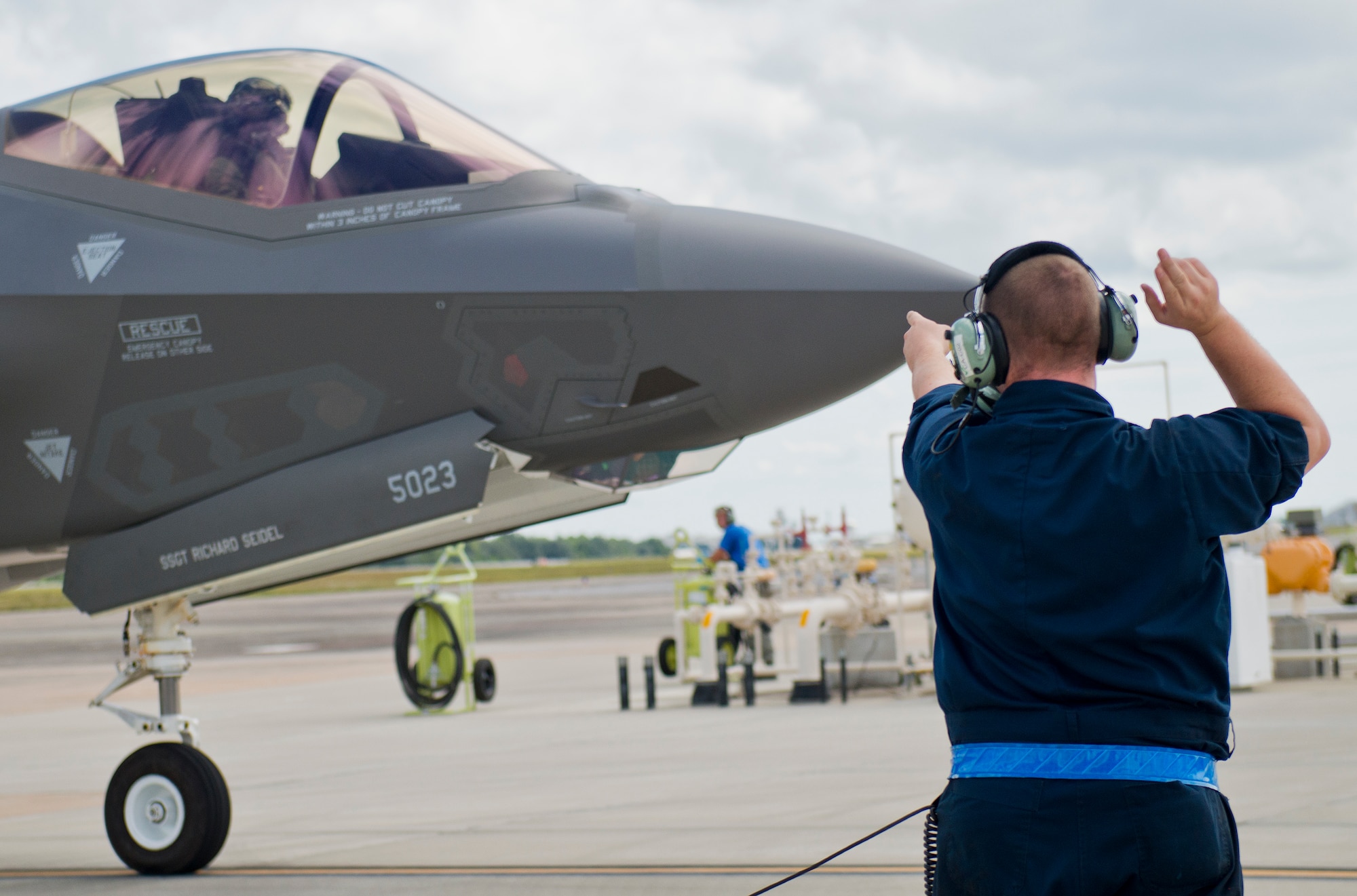 Senior Airman Travis Barry, 33rd Aircraft Maintenance Squadron, marshals out an F-35A Lightning II after a hot pit refuel session at Eglin Air Force Base, Fla.  All of the F-35 variants use the refueling areas in conjunction with the 96th Logistics Readiness Squadron’s fuels flight. (U.S. Air Force photo/Samuel King Jr.)  