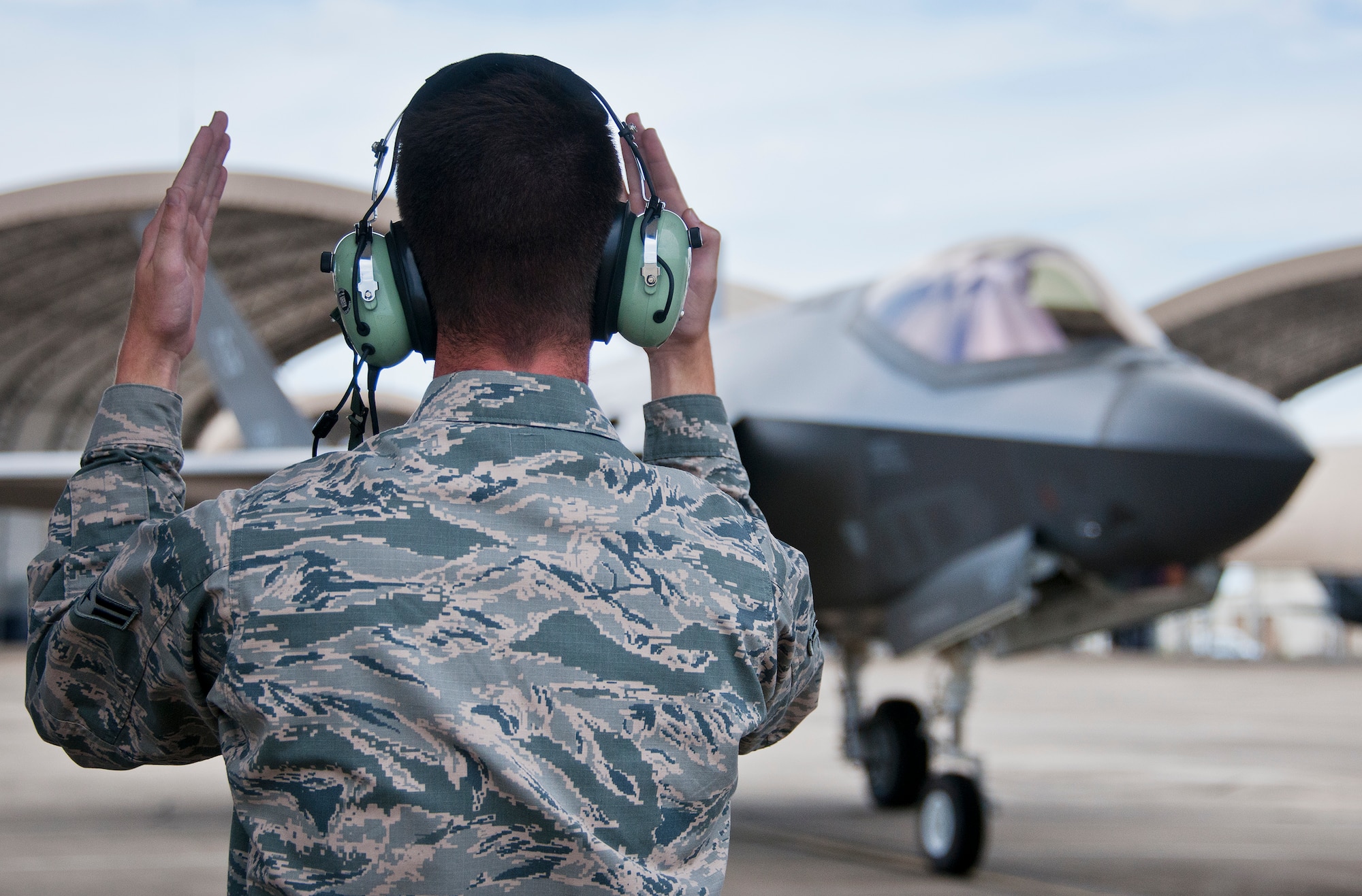 Airman 1st Class John Patterson, 33rd Aircraft Maintenance Squadron, marshals in an F-35A Lightning II after a sortie at Eglin Air Force Base, Fla.  The 33rd Maintenance Group is responsible for the maintenance of the Air Force’s joint strike fighter fleet on base.  (U.S. Air Force photo/Samuel King Jr.)