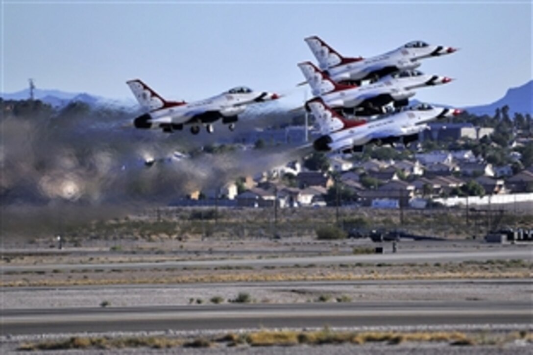The U.S. Air Force Thunderbirds aerial demonstration team takes off for its performance during an open house event on Nellis Air Force Base, Nev., Nov. 8, 2014.