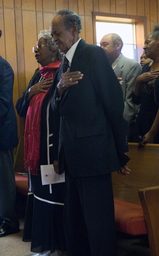 William J. Brashear (right), a Montford Point Marine, stands beside his wife, Adele G. Brashear, during the Pledge of Allegiance at the Mount Era Baptist Church in Morgan City, La., Nov. 15, 2014. Brashear was presented the Congressional Gold Medal, which is the nation’s highest honor given to civilians and is presented to all Montford Point Marines to recognize their contribution to the Marine Corps and the United States of America. Montford Point Marines were the first African-Americans allowed to enlist in the Marine Corps. 