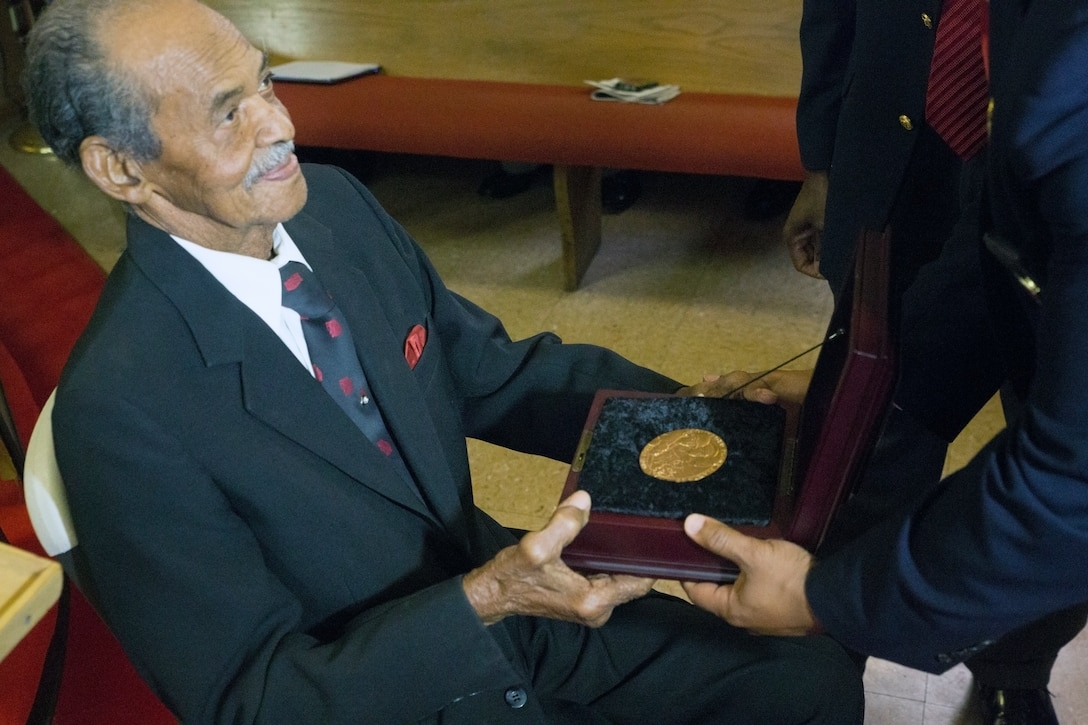 William J. Brashear (left), a Montford Point Marine, receives the Congressional Gold Medal during a ceremony held at Mount Era Baptist Church in Morgan City, La., Nov. 15, 2014. The Congressional Gold Medal is the nation’s highest civilian honor and is awarded by Congress for distinguished achievement. On Nov. 23, 2011, President Barrack Obama signed into legislation a law that awarded the Congressional Gold Medal to all Montford Point Marines who were the first African-Americans allowed to enlist in the Marine Corps.