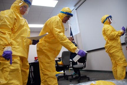 Members of the Wisconsin National Guard’s Joint Health Assistance Team train on procedures to decontaminate equipment as part of the team’s Ebola Virus Disease response training Oct. 31, 2014, at Volk Field, Wisconsin. Two teams of Soldiers and Airmen were validated by the Wisconsin Department of Health Services to respond in the event of an Ebola outbreak in the state. 