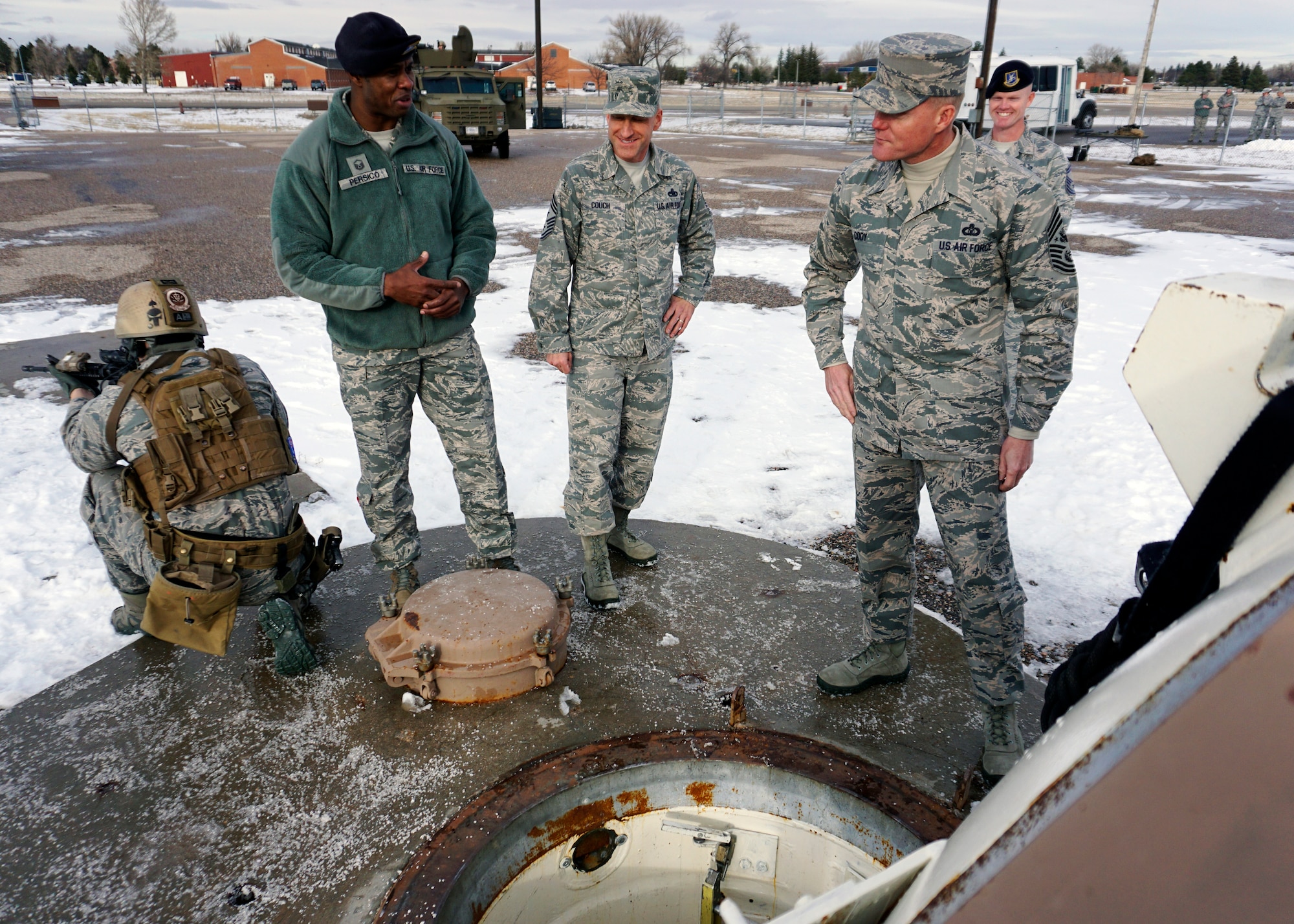 Chief Master Sgt. of the Air Force James Cody speaks with Master Sgt. Alan Persico during a topside tour of the U-01 training launch facility at F.E. Warren Air Force Base, Wyo. Persico explained the methods the 90th Security Forces Group Tactical Response Force Airmen use to enter and clear a launch facility. Persico is with the 790th Missile Security Forces Squadron. (U.S. Air Force photo/Lan Kim)