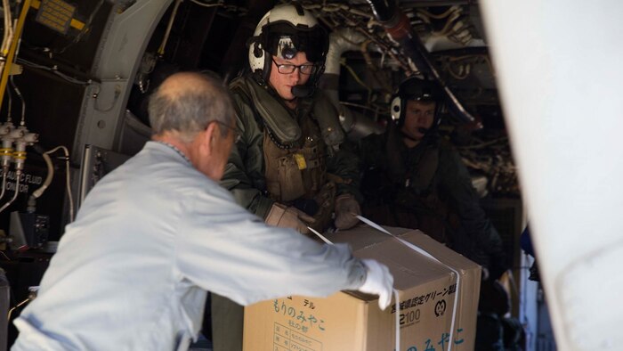 A Japanese volunteer from the Oshima Fire Department and U.S. Marine Corps Cpl. Robert C. Austin quickly offload humanitarian aid and disaster relief supplies from an MV-22B Osprey tiltrotor aircraft Nov. 8 during Tomodachi relief exercise 15.2 near Izu Oshima Island, Tokyo Metropolis Prefecture, Japan. TREX 15.2 is an annual, bilateral training exercise that simulates humanitarian assistance and disaster relief missions in the Japan while strengthening U.S. and Japanese alliance. During the offload, approximately 600 pounds of food, water, blankets, and medical supplies were transported from the Osprey to a waiting truck in less than eight minutes. Austin, from Grand Ledge, Michigan, is an Osprey crew chief with Marine Medium Tiltrotor Squadron 265, Marine Aircraft Group 36, 1st Marine Aircraft Wing, III Marine Expeditionary Force. 