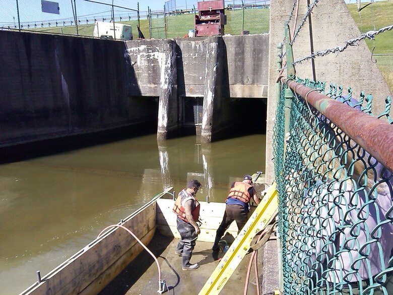 Repair party members Jim Draper and Chris Bushaw drill the holes for the injection ports. 