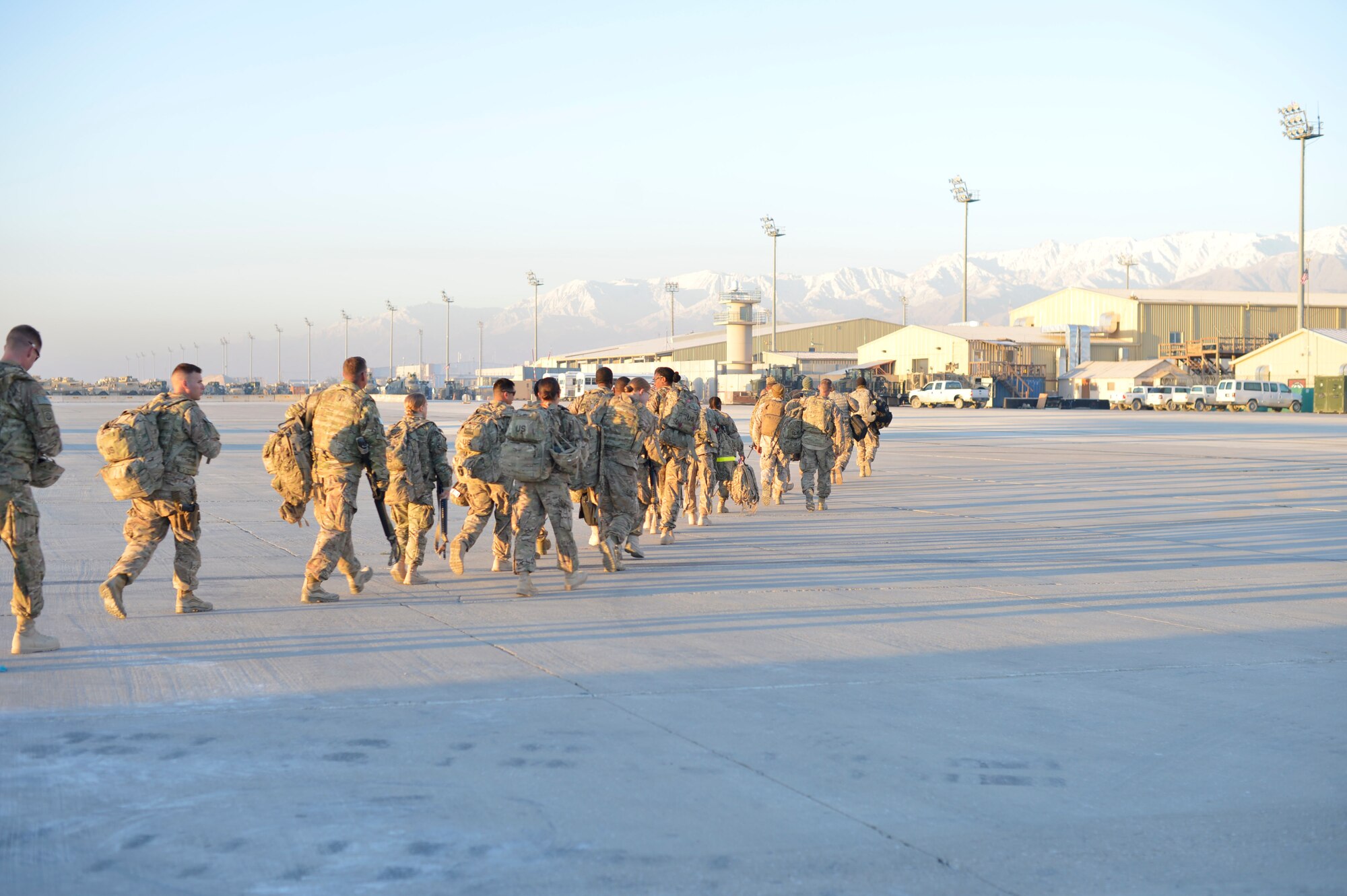 Soldiers arriving from Shindand, Afghanistan, head to the passenger terminal at Bagram Air Field, Afghanistan, Nov. 9, 2014, after arriving on a C-130 Hercules. In the last two months, the 455th Air Expeditionary Wing has pushed 2,200 passengers and 4,300 short tons of cargo out of Shindand, Afghanistan. (U.S. Air Force photo by Staff Sgt. Jennifer M. Stai/released)
