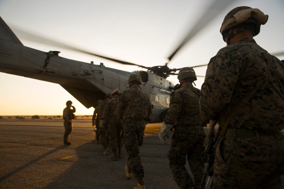 Marine Infantry Officer Course (IOC) students approach a CH-53E Super Stallion helicopter on the Marine Corps Air Station Yuma, Ariz., Auxiliary Landing Field 2, Wednesday, August 18, 2014. The students were about to engage in a fast rope drill out of the aircraft,  and gain the skills necessary to complete IOC’s final exercise, Talon Reach IV.