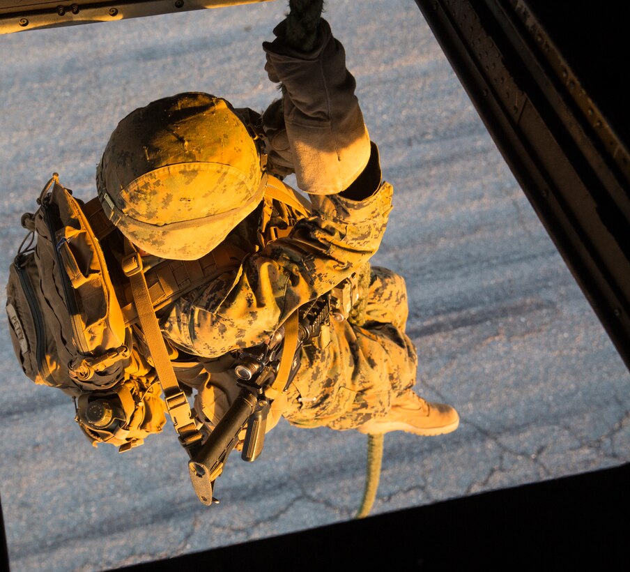 A Marine Infantry Officer Course (IOC) student exits a CH-53E Super Stallion helicopter during a fast rope drill on the Marine Corps Air Station Yuma, Ariz., Auxiliary Landing Field 2, Wednesday, August 18, 2014. The fast rope training instilled in these Marines the skills necessary to complete IOC’s final exercise, Talon Reach IV.