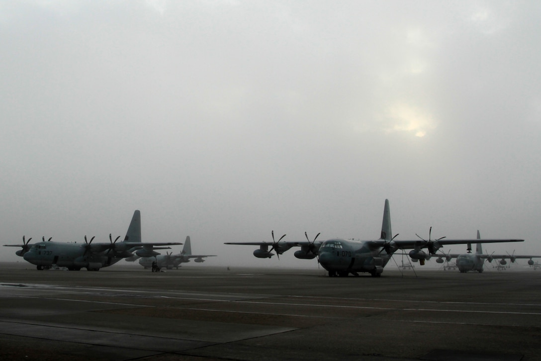 Several KC-130J Super Hercules airplanes belonging to Marine Aerial Refueler Transport Squadron 252 emerge from a morning fog on the flightline at Marine Corps Air Station Cherry Point, N.C., Nov. 17, 2014.
Cherry Point is home to 2nd Marine Aircraft Wing and several of its squadrons. Cherry Point's runways operate 24/7, 365 days each year, and the air station hosts squadrons that specialize in air-to-ground attack support; electronic warfare; aerial transport and refueling; and sea and land search and rescue.