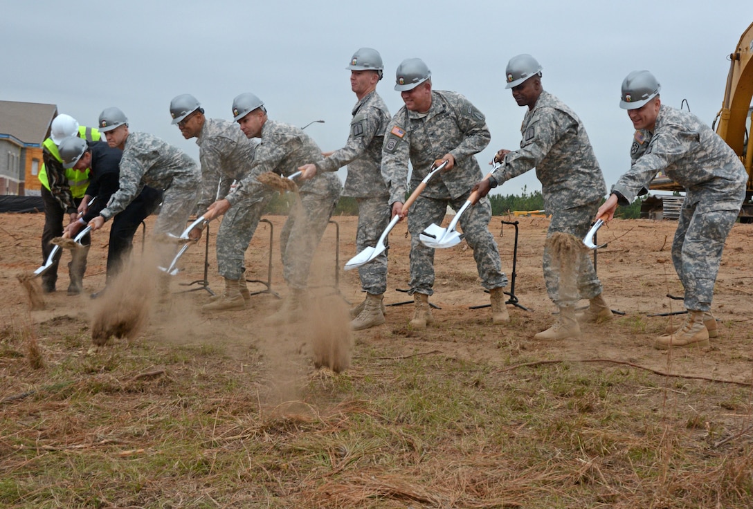 The 528th Sustainment Brigade (Airborne) officially broke ground on its 120,000 square foot brigade headquarters facility during ceremonies Nov. 13, 2014. Taking part in the symbolic first dig is (left to right) Ben Polote, Richard Holcomb,  Brig. Gen. Darsie Rogers, SAD Commander Brig. Gen. David Turner, Col. Daniel Rickleff, Sgt. Maj. Bradley Stout and Col. Steven Baker, Sgt. Maj. Tramell Finch and Lt. Col. Jesse Wightman. The facility signifies a modernization effort that will greatly improve the support the 528th is able to provide to Army Special Operations Soldiers worldwide. 