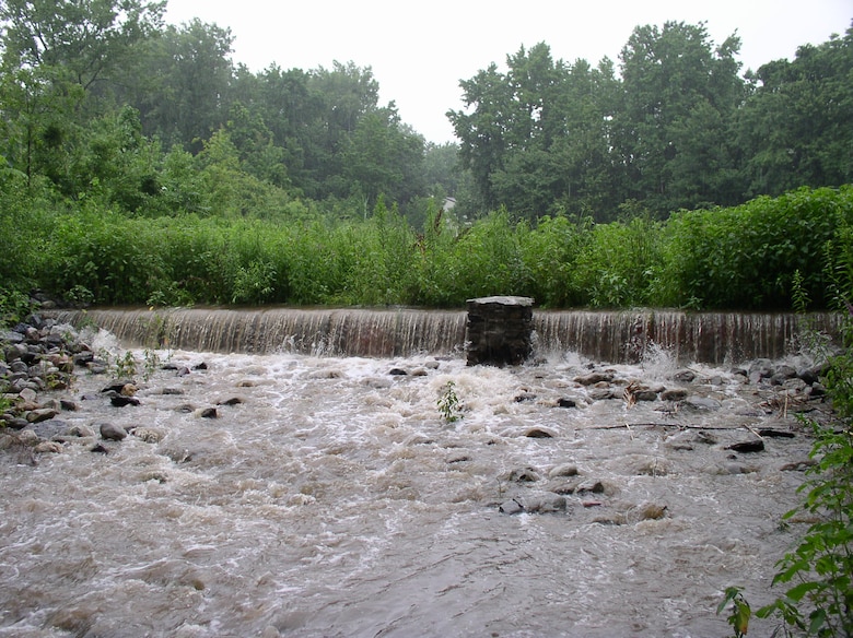 Water flows over a weir in Arbutus Creek, where the NYCDEP maintains a system of best management practices for stormwater control and conveyance.