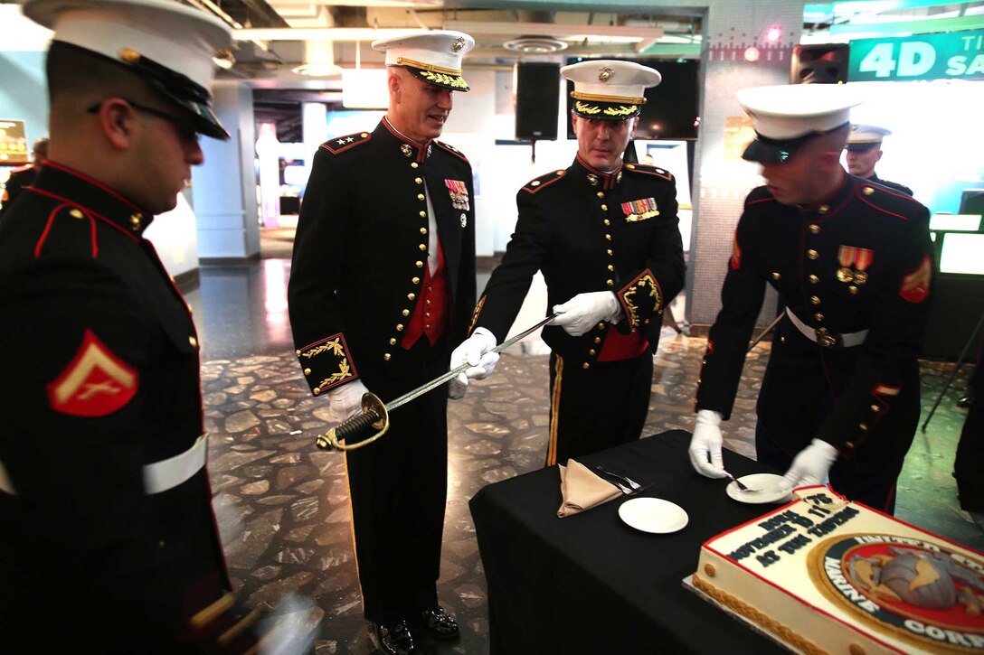 Maj. Gen. Paul W. Brier, commanding general of 4th Marine Division, stands next to Lt. Col. Christopher A. Davis, commanding officer of 3rd Battalion, 14th Marine Regiment, 4th Marine Division, as he passes a noncommissioned officer sword to a Marine during a cake-cutting ceremony during 3rd Bn., 14th Marines birthday ball at Adventure Aquarium in Camden, New Jersey, Nov. 15, 2014. Attending the ceremony was several previous commanders and former staff of 3rd Bn., 14th Marines who were invited to share in the festivities. (U.S. Marine Corps Photo by Cpl. J. Gage Karwick/Released)  