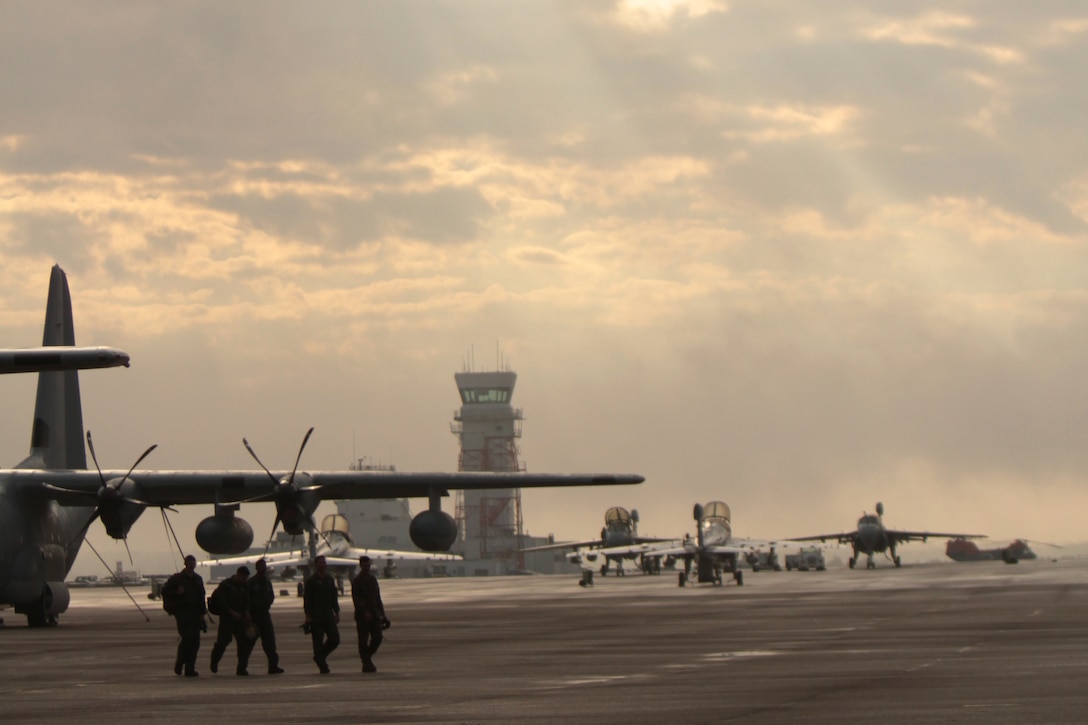 Marines belonging to Marine Aerial Refueler Transport Squadron 252 walk along the flightline after conducting maintenance on a KC-130J Super Hercules at Marine Corps Air Station Cherry Point, N.C., Nov. 17, 2014.  Cherry Point is home to 2nd Marine Aircraft Wing and several of its squadrons. Cherry Point's runways operate 24/7, 365 days each year, and the air station hosts squadrons that specialize in air-to-ground attack support; electronic warfare; aerial transport and refueling; and sea and land search and rescue.