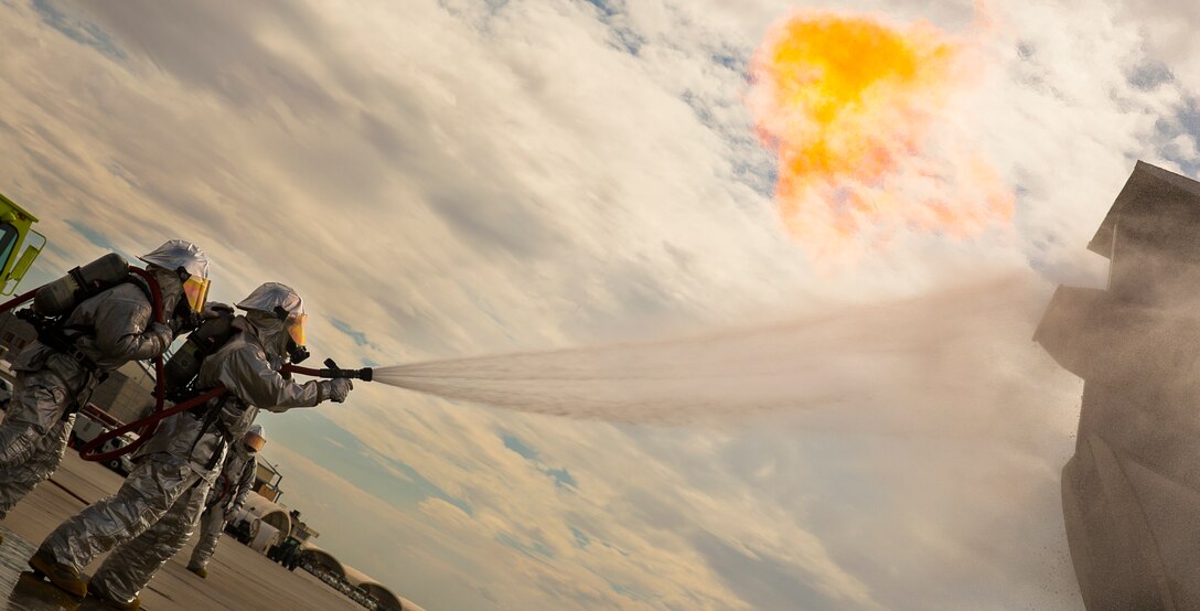 Aircraft rescue and firefighting Marines with Headquarters and Headquarters Squadron at Marine Corps Air Station Yuma, Ariz., extinguish fires on a mobile aircraft firefighting training device as a demonstration for aviation ground support (AGS) students of the Weapons and Tactics Instructor course 1-15 on MCAS Yuma’s flight line, Tuesday, Sept. 9 2014. The demonstration acquainted the AGS students, who come from a variety of technical backgrounds and military occupational specialties, with the flight line’s terminology, markings and resident services.