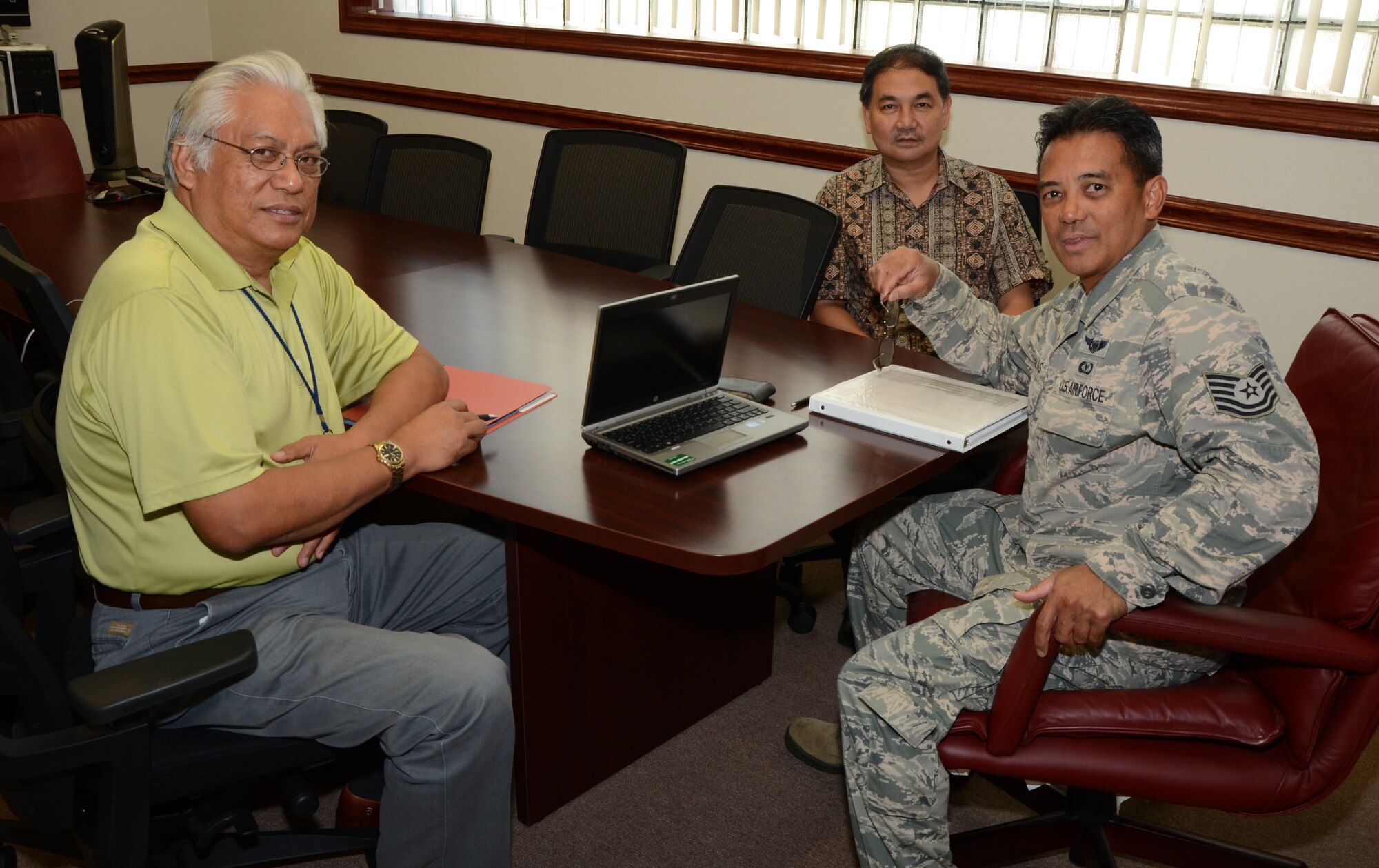 Tech. Sgt. Randall Mamalias, right, ground safety manager for the 624th Regional Support Group, Hickam Field, Hawaii, meets with safety contractors Roger Urbi, left, and Marc Sibal, center, from Pearl Harbor Naval Station, Hawaii, at the 624th RSG headquarters building conference room, Nov. 10, 2014. The contractors conducted an annual assessment of the 624th RSG’s safety office to determine what elements of the safety program required Joint Base Pearl Harbor-Hickam support. (U.S. Air Force photo by Tech Sgt. Phyllis Keith)