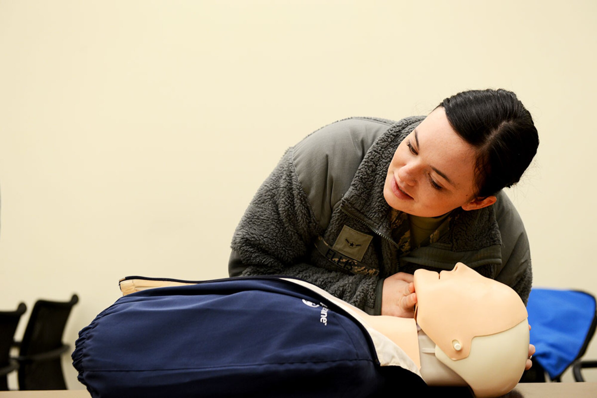 Air Force Airman Tabitha Ellis, a fitness specialist with the 673d Force Support Squadron simulates a breathing check for a dummy as part of her Automatic External Defibrillator test for Polar Force 14-9 at Elmendorf Fitness Center November 4, 2014.  Polar Force 14-9 is part two of a base-wide exercise to gauge unit readiness. (U.S. Air Force Photo by Airman 1st Class Kyle Johnson)