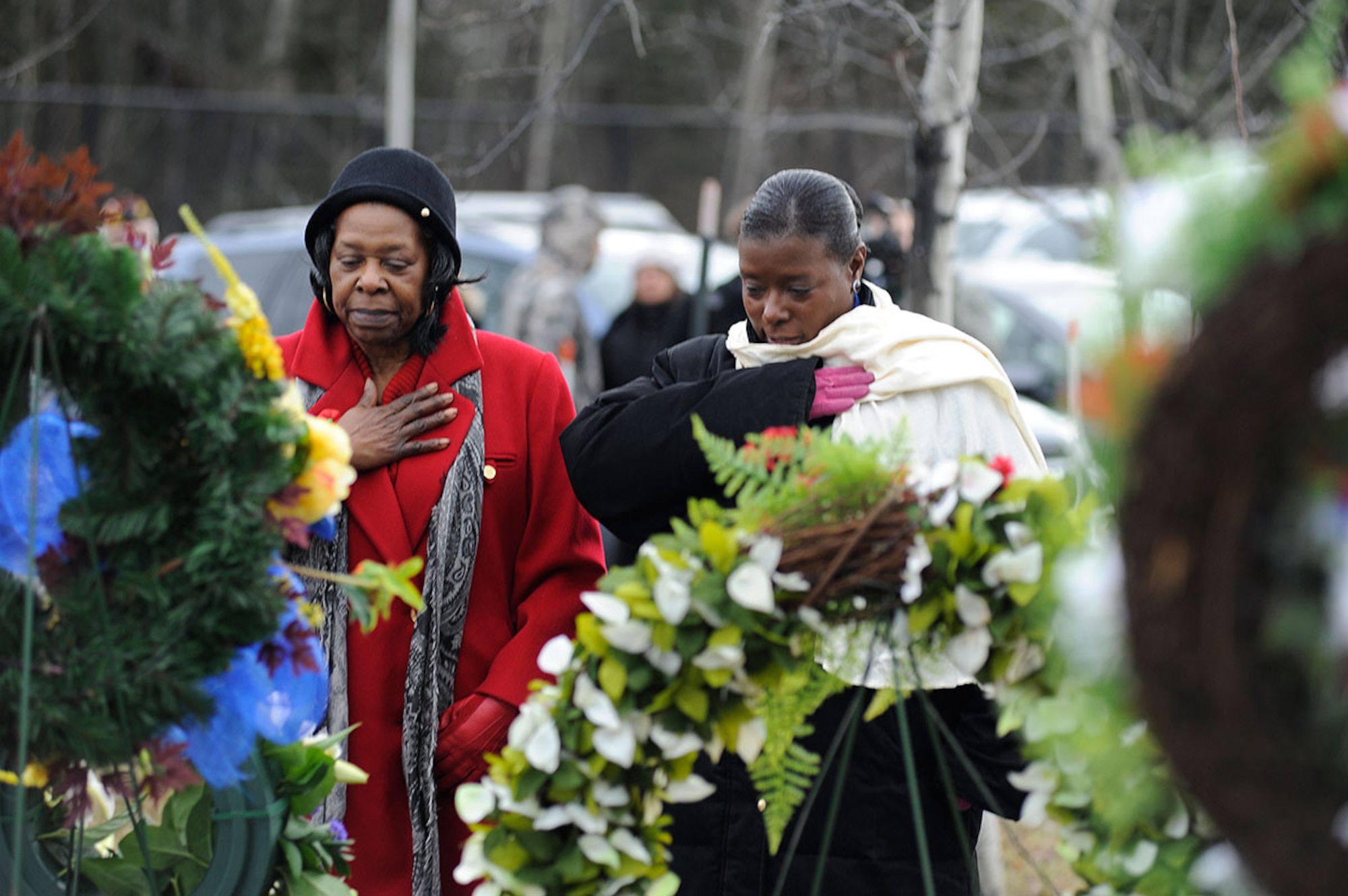 Estella Manley, left, and Dawn Bundick pay their respects after placing a wreath during a Remembrance Day ceremony hosted by the Royal Canadian Air Force in the Fort Richardson National Cemetery at Joint Base Elmendorf-Richardson, Alaska, Nov. 11. Manley and Bundick are the junior vice president and department president of Ladies Auxiliary Veterans of Foreign Wars, respectively. Bundick is also a Navy veteran with 10 years of service. (U.S. Air Force photo/Staff Sgt. Robert Barnett)