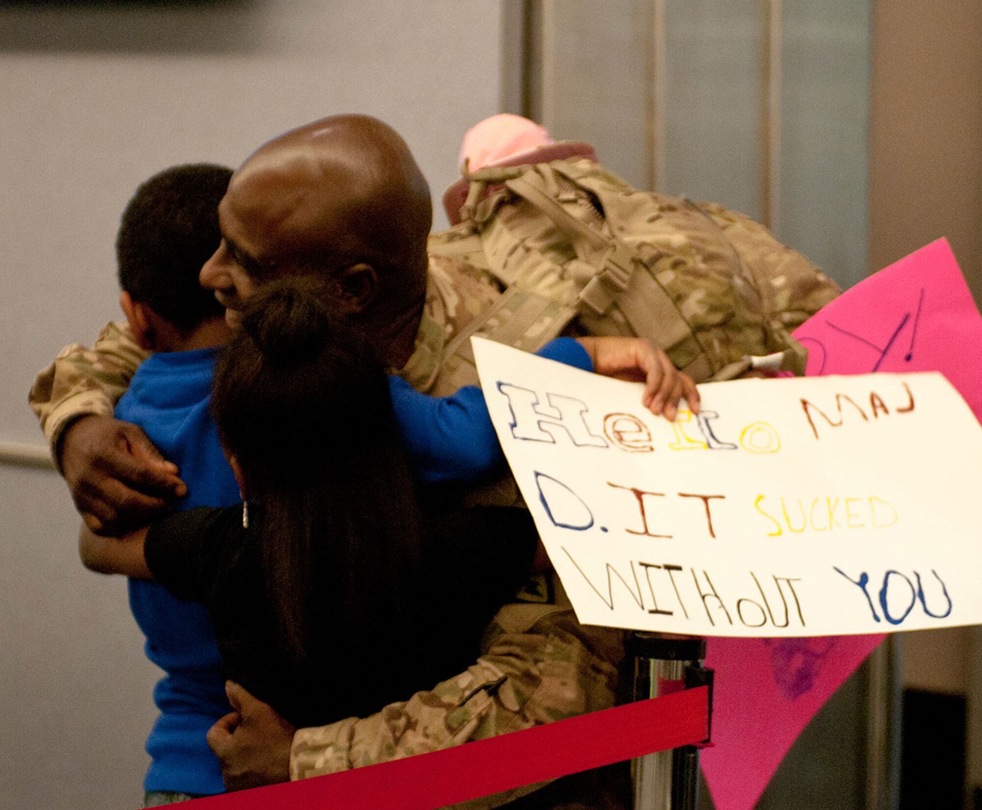 Maj. Ernest Dorema, officer in charge of the critical care trauma nurse section of the 8th FST, greets his children, Elliot and Leilani, at Ted Stevens International Airport in Anchorage, Alaska, Oct. 4. Maj. Dorema returned from a 9 month deployment with the 8th Forward Surgical Team, 725th Support Battalion, 4th Brigade, 25th Infantry Division (Airborne). (U.S. Army photo by SSG Daniel Love/Released)