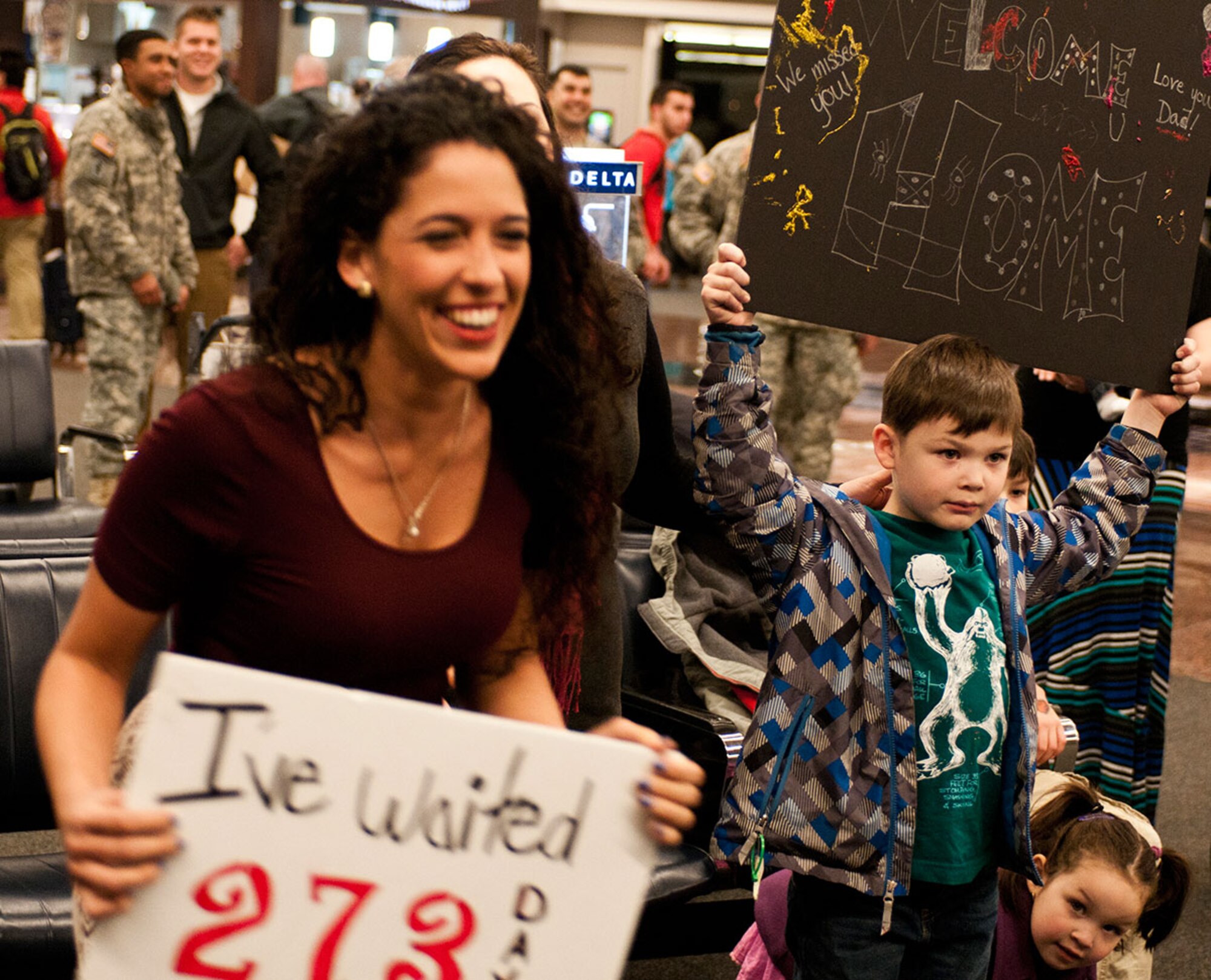 Jackie Triolo, wife of Spc. Anthony Triolo breaks away from a crowd of family members and friends to greet her husband at Ted Stevens International Airport in Anchorage, Alaska, Oct. 4. Spc. Triolo returned from a 9 month deployment with the 8th Forward Surgical Team, 725th Support Battalion, 4th Brigade, 25th Infantry Division (Airborne). (U.S. Army photo by SSG Daniel Love/Released)