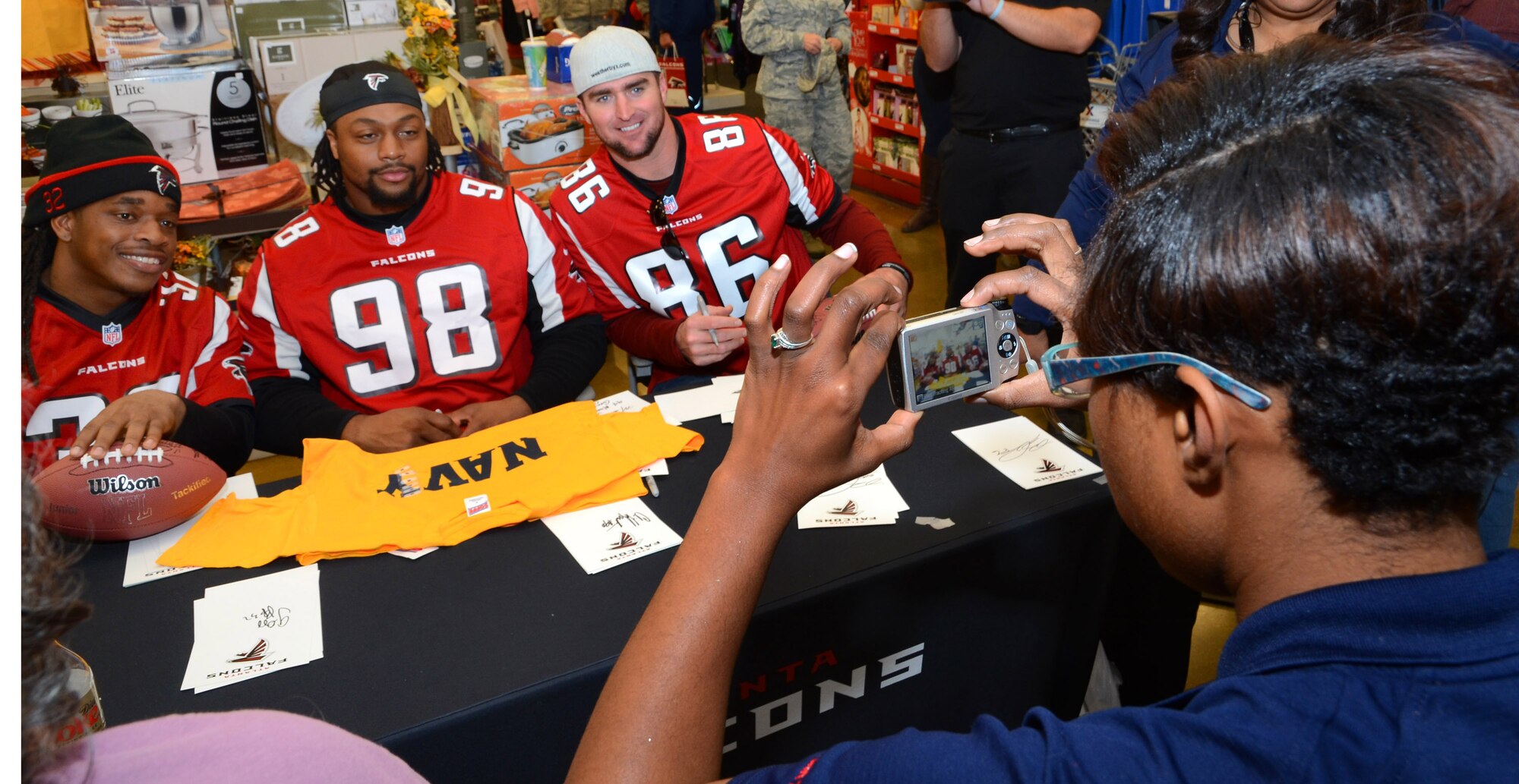 Atlanta Falcons players, Jacquizz Rodgers, Cliff Matthews, and Bear Pascoe pose for a picture at the Dobbins ARB base exchange in Marietta, Georgia, Nov. 18, 2014. The Falcons players spent a couple of hours on the base to thank the various military service members assigned for what they do every day for our country.  (U.S. Air Force photo/ Brad Fallin /Released)
