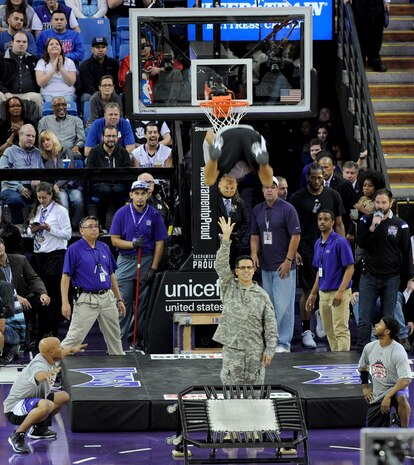 A U.S. Army service member participates in a basketball challenge during the Sacramento Kings Military Appreciation Night at the Sleep Train Arena in Sacramento, Calif., Nov. 15, 2014. The Kings held the military-themed game in honor of Veterans Day. (U.S. Air Force photo by Staff Sgt. Robert M. Trujillo/Released)