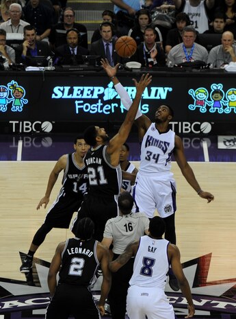 Tim Duncan, San Antonio Spurs power forward, and Jason Thompson, Sacramento Kings power forward, leap at tip-off during Military Appreciation Night at the Sleep Train Arena in Sacramento, Calif., Nov. 15, 2014. The Kings defeated the San Antonio Spurs, 94-91. (U.S. Air Force photo by Staff Sgt. Robert M. Trujillo/Released)