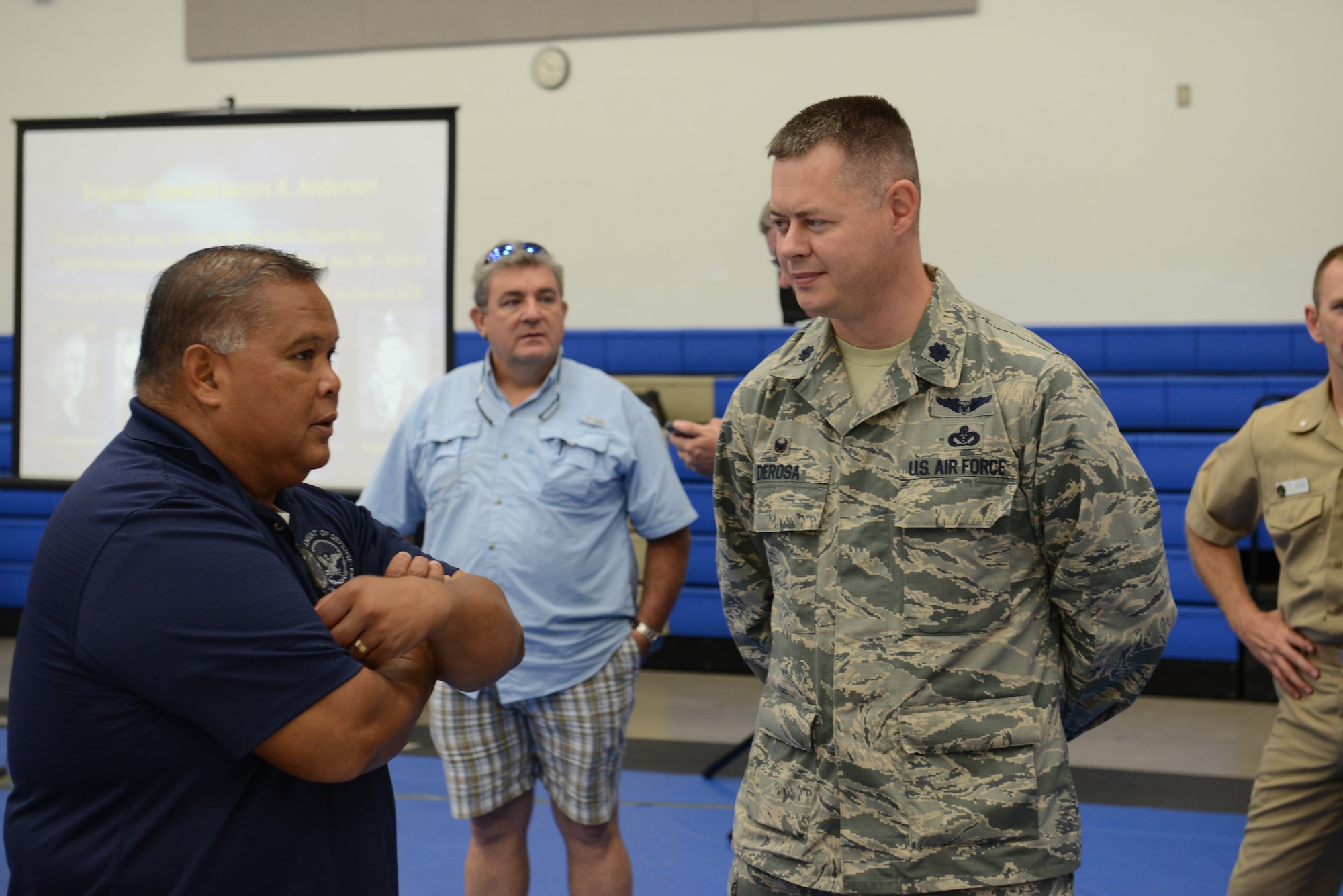 Lt Col. Andrew Derosa, 554th RED HORSE Squadron commander, interacts with retirees at the Coral Reef Fitness Center Nov. 15 2014 on Andersen Air Force Base Guam. The retirees shared stories from their time served in the Armed Forces with active duty military members in attendance. (U.S. Air Force Photo by Senior Airman Adarius Petty.)
