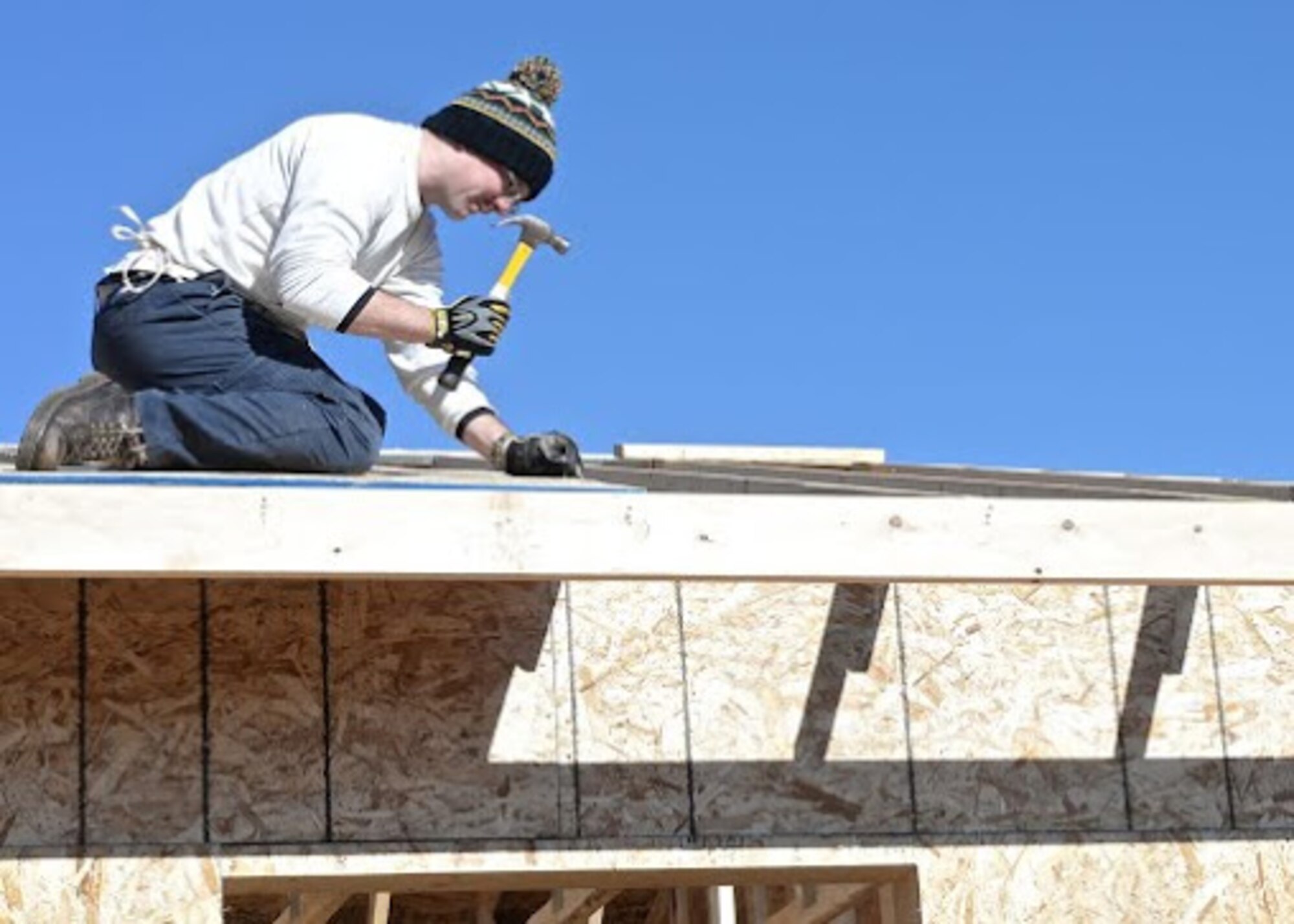 Senior Airman Travis Bellefeuille, 28th Operations Support Squadron targeteer, builds a roof during a Habitat for Humanity project in Summerset, S.D., Nov. 8, 2014. Bellefeuille and several other Ellsworth Airmen dedicated their time constructing a roof for a house that will be provided to a Habitat family in need. Habitat Black Hills Area volunteers have helped house over 300 people in the local area. (U.S. Air Force photo by Senior Airman Anania Tekurio/Released)