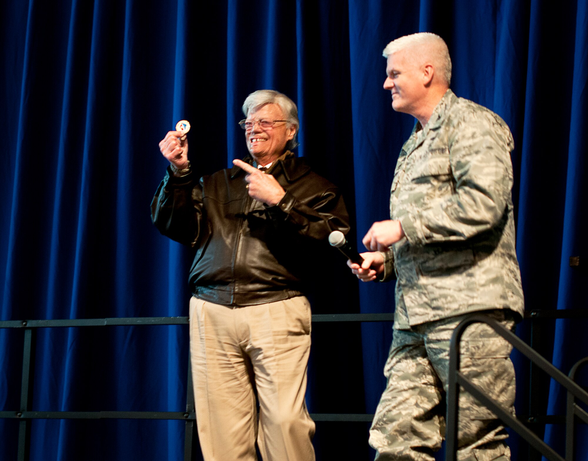 U.S. Air Force Col. James Johnson, Commander of the 133rd Airlift Wing, gives Mr. Dave Roever, a Navy Vietnam Veteran, a unit coin after Roever shared his story on resilience in St. Paul, Minn., Dec. 15, 2014. Roever triumphed over both physical and mental obstacles in his life and is shared his experience with Airmen from the 133rd Airlift Wing.  (U.S. Air National Guard photo by Staff Sgt. Austen Adriaens/Released)