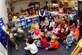 Airman 1st Class Bradley Simmons, 1st Maintenance Squadron ammunitions technician, reads to children at the Child Development Center at Langley Air Force Base, Va., Nov. 13, 2014. In his spare time, Simmons enjoys reading to children for the Reading Enriches Children Program and at the CDC. (U.S. Air Force photo by Airman 1st Class Breonna Veal/Released) 