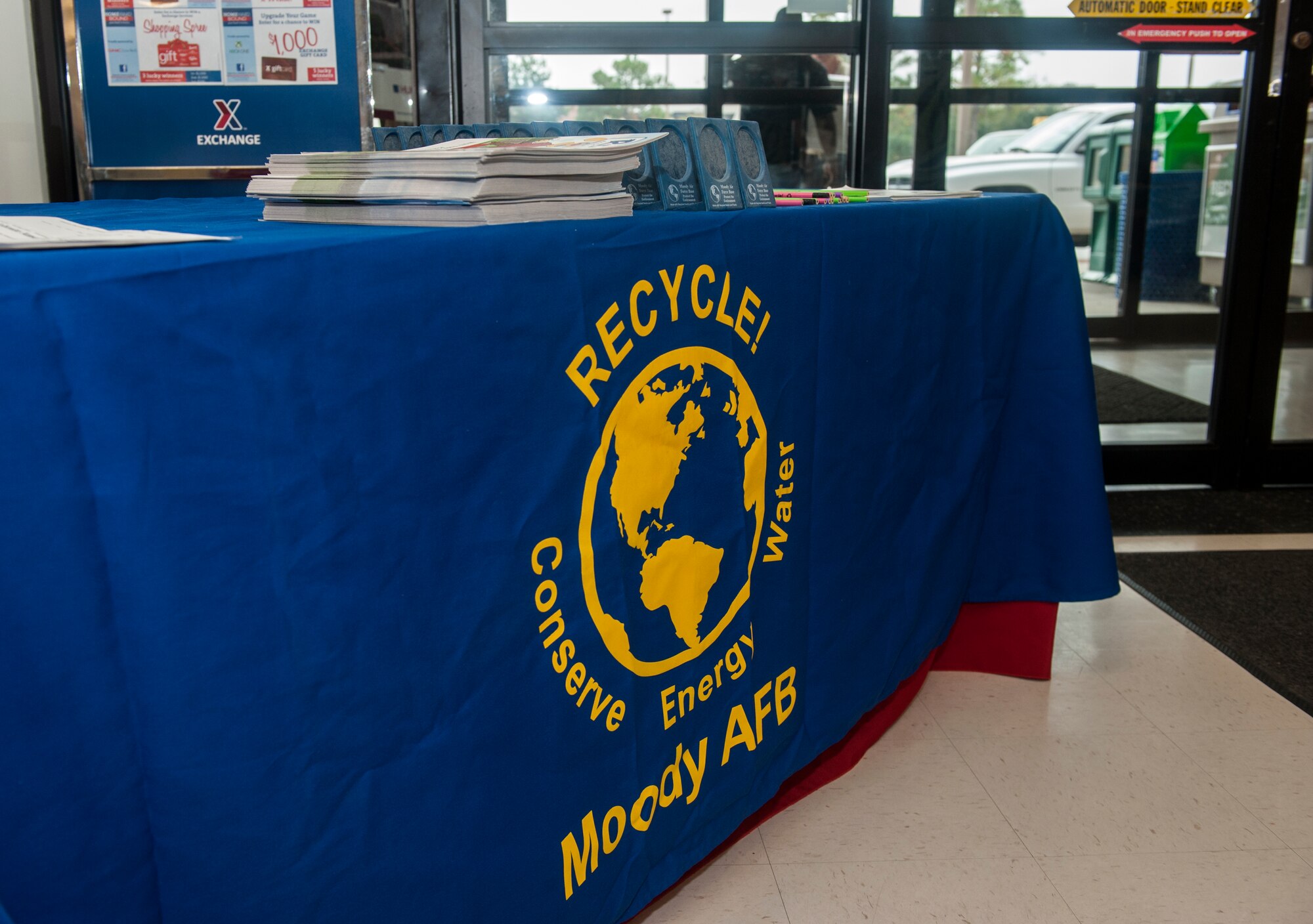 A table with information on recycling sits at the entrance to the Moody Air Force Base, Ga., Exchange, Nov. 13, 2014. The table, which was set up for America Recycles Day, is part of a larger initiative by environmental specialists to educate people on the importance of preserving the environment. (U.S. Air Force photo by Senior Airman Jarrod Grammel/Released) 

