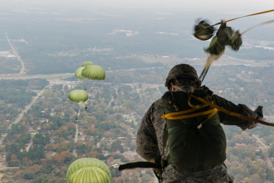 Airmen from the 820th Base Defense Group jump out of the back of an HC-130J Combat King II Nov. 13, 2014, over Moody Air Force Base, Ga. After exiting the aircraft, the Airmen parachuted for 45-60 seconds before landing. (U.S. Air Force photo by Airman 1st Class Ryan Callaghan/Released)