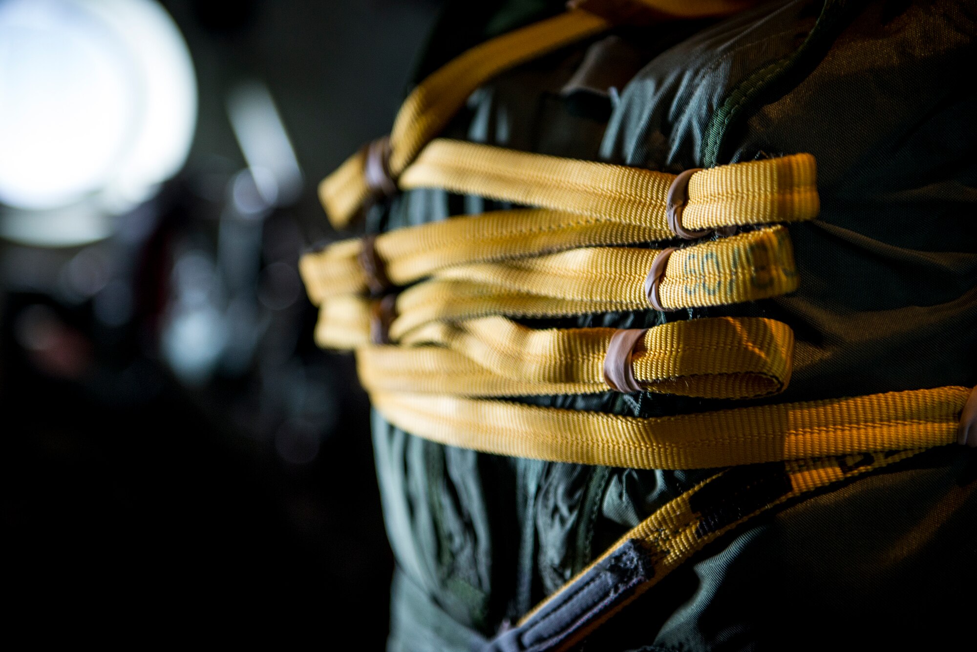 Airmen intricately wind a parachute static-line Nov. 13, 2014, over Moody Air Force Base, Ga. The static line is wound precisely to make sure it doesn’t get caught before the jumper exits the plane. (U.S. Air Force photo by Airman 1st Class Ryan Callaghan/Released)