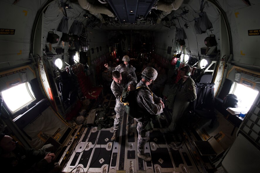 Airmen from the 820th Base Defense Group prepare their parachutes for a static-line jump Nov. 13, 2014, over Moody Air Force Base, Ga. Airmen are required to jump periodically to maintain their proficiency. (U.S. Air Force photo by Airman 1st Class Ryan Callaghan/Released)