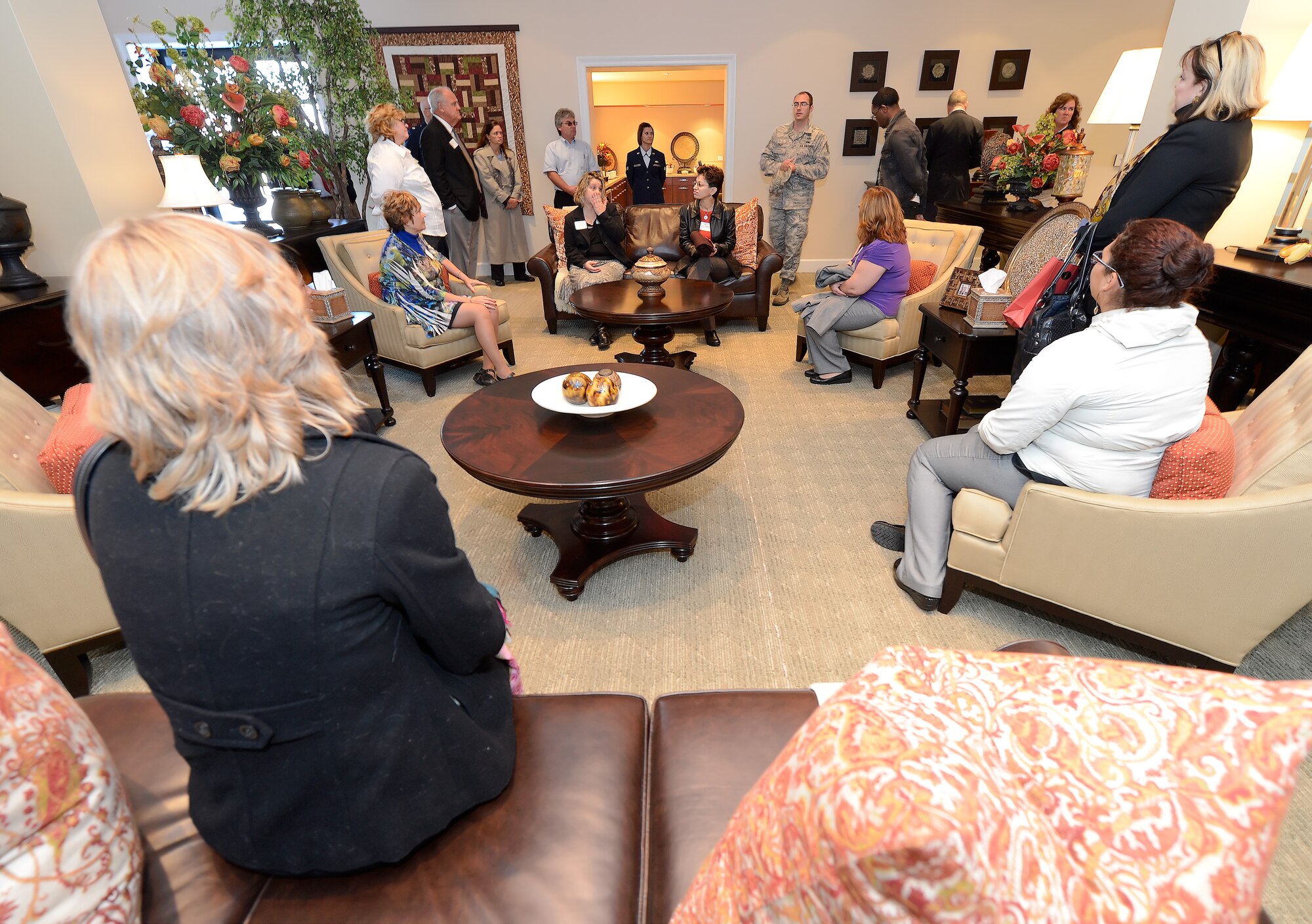 Members of a group touring the Fisher House at Dover Air Force Base, Del., listen intently to a briefing on the facilities importance and function as part of Air Force Mortuary Affairs mission on Nov. 10, 2014. The tour was part of the 2014 Military Construction Breakfast hosted by the Central Delaware Chamber of Commerce. (U.S. Air Force photo/Greg L. Davis)      